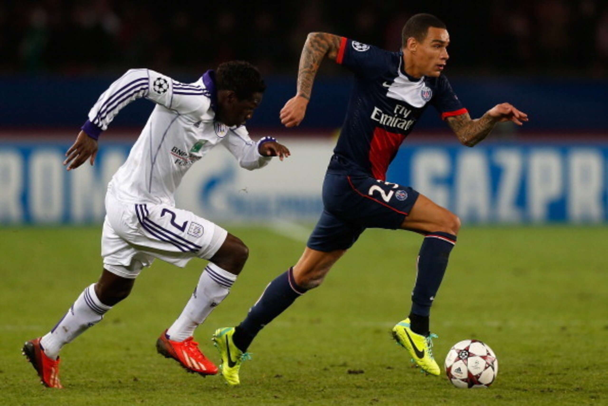 PARIS, FRANCE - NOVEMBER 05:  Gregory van der Wiel of PSG is chased by Fabrice N'Sakala of Anderlecht during the UEFA Champions League Group C match between Paris Saint Germain and RSC Anderlecht at Parc des Princes on November 5, 2013 in Paris, France.  