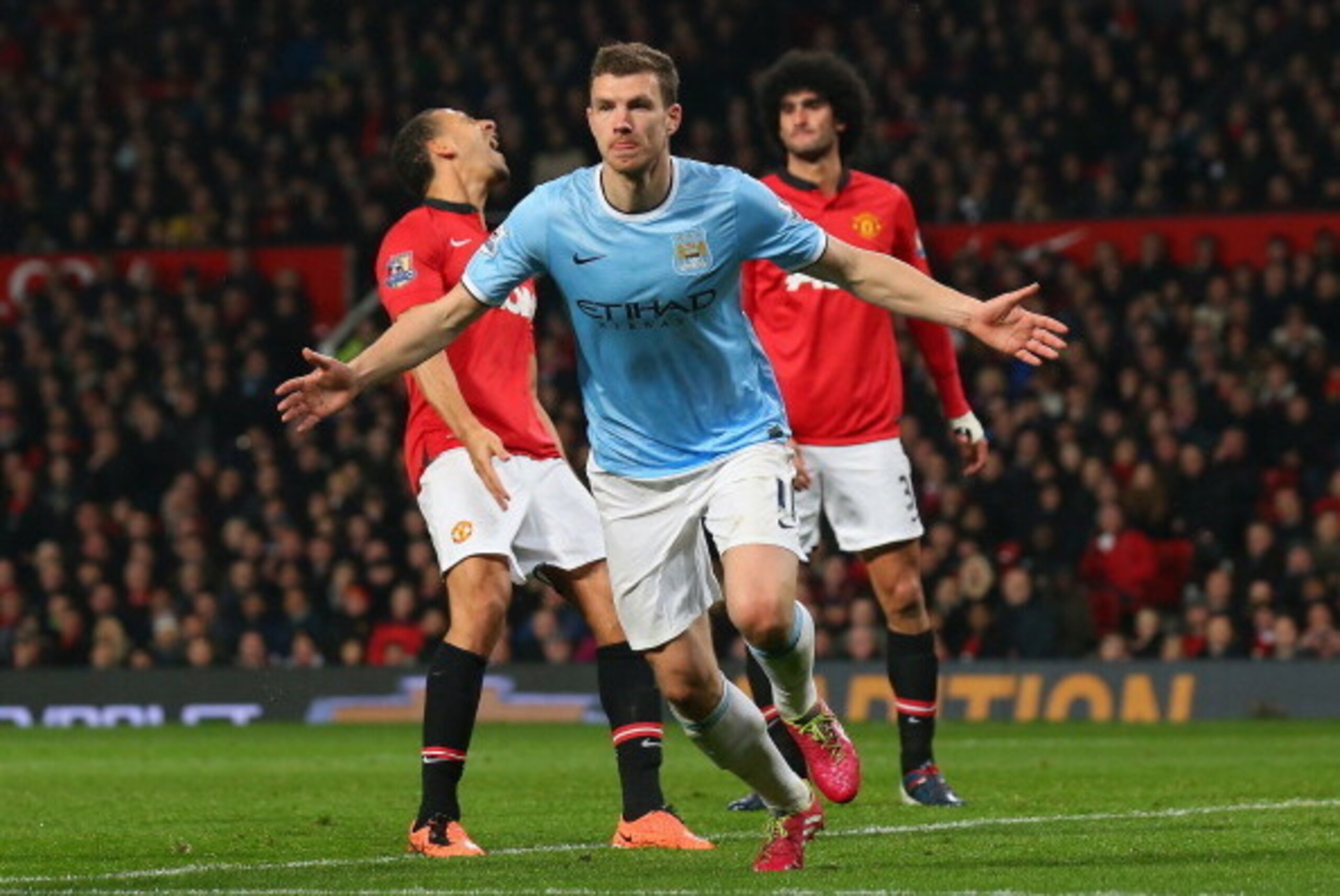 MANCHESTER, ENGLAND - MARCH 25:  Edin Dzeko of Manchester City celebrates scoring the second goal during the Barclays Premier League match between Manchester United and Manchester City at Old Trafford on March 25, 2014 in Manchester, England.  (Photo by A