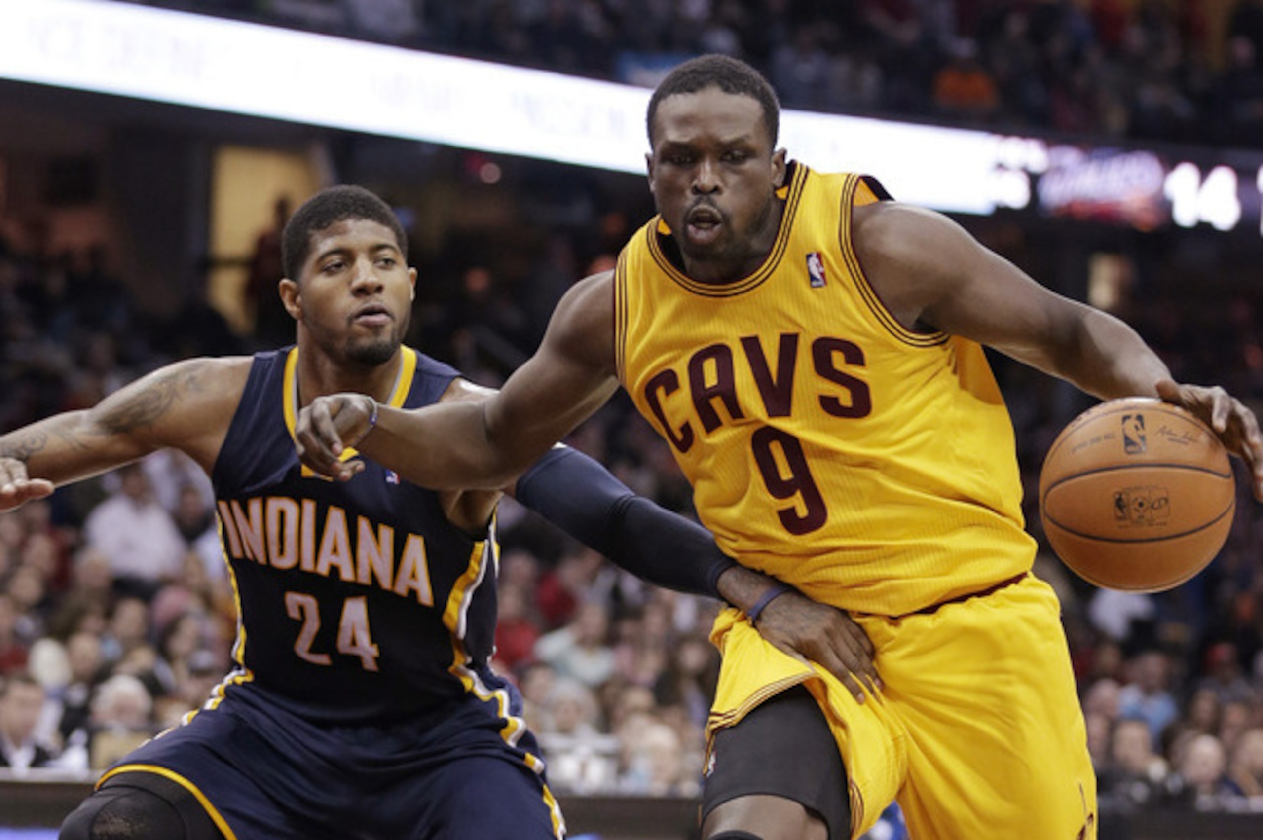 Luol Deng driving on Paul George.
