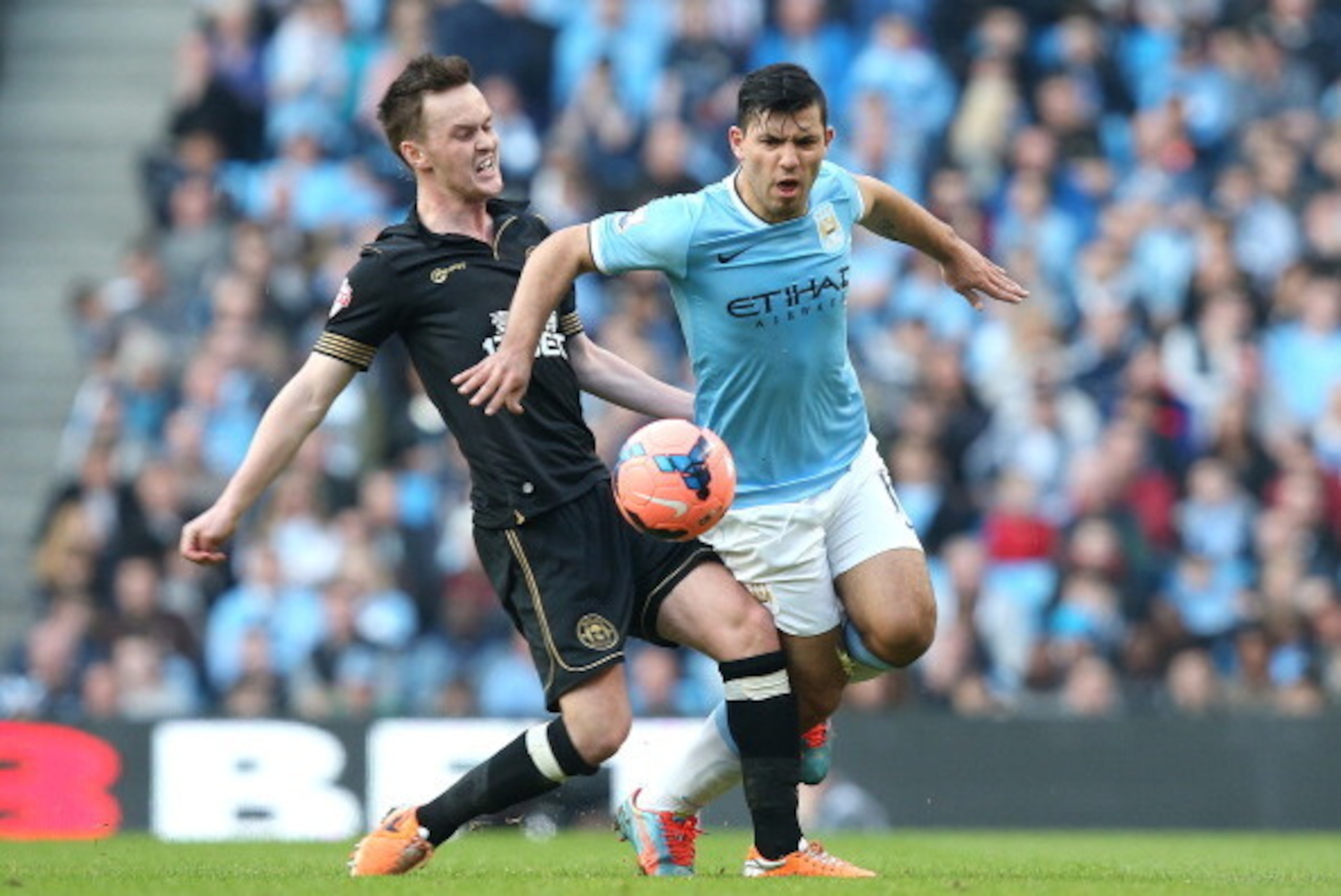 MANCHESTER, ENGLAND - MARCH 09:   Sergio Aguero of Manchester City battles with Josh McEachran of Wigan Athletic during the FA Cup Quarter-Final match between Manchester City and Wigan Athletic at the Etihad Stadium on March 9, 2014 in Manchester, England
