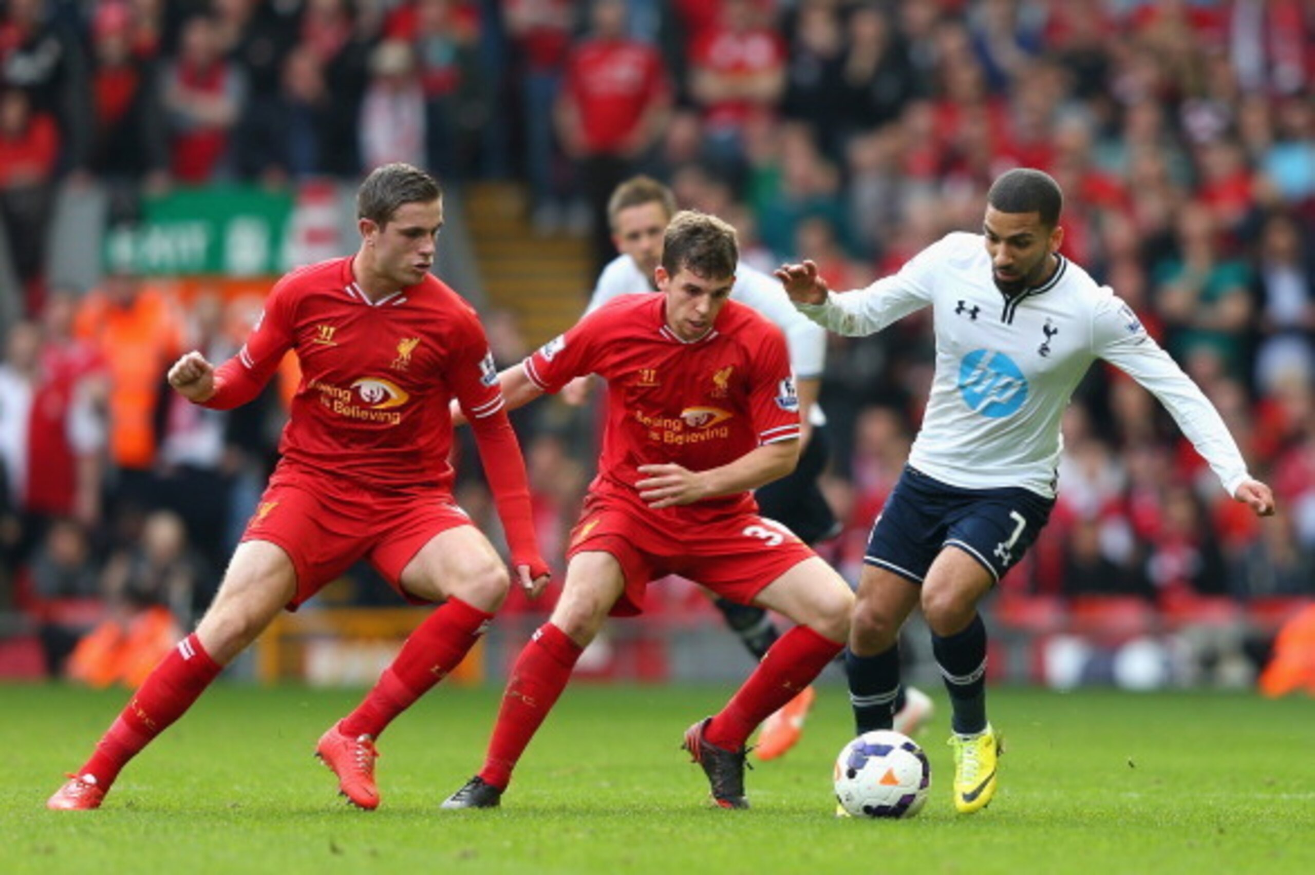 LIVERPOOL, ENGLAND - MARCH 30:  Aaron Lennon of Tottenham Hotspur competes with Jordan Henderson (l) and Jon Flanagan of Liverpool during the Barclays Premier League match between Liverpool and Tottenham Hotspur at Anfield on March 30, 2014 in Liverpool, 