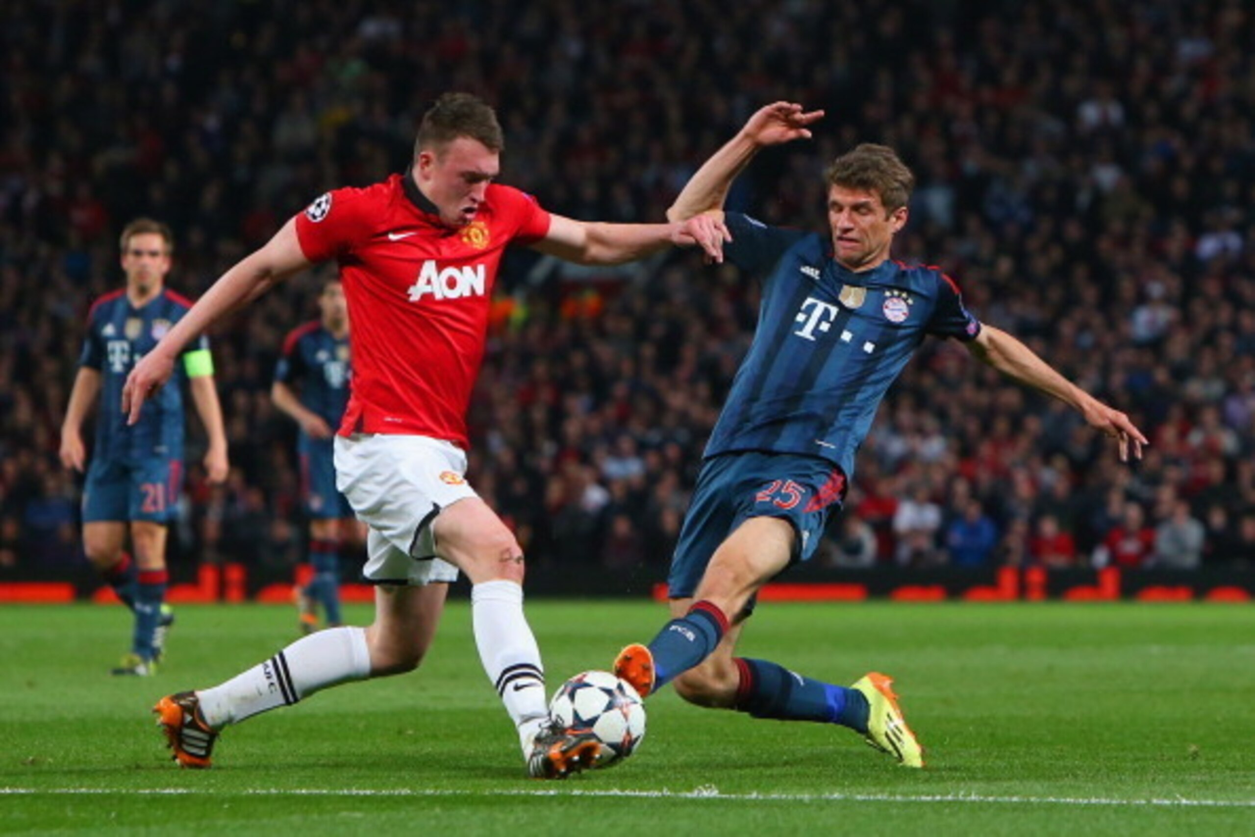 MANCHESTER, ENGLAND - APRIL 01:  Phil Jones of Manchester United is tackled by Thomas Mueller of Bayern Muenchen during the UEFA Champions League Quarter Final first leg match between Manchester United and FC Bayern Muenchen at Old Trafford on April 1, 20