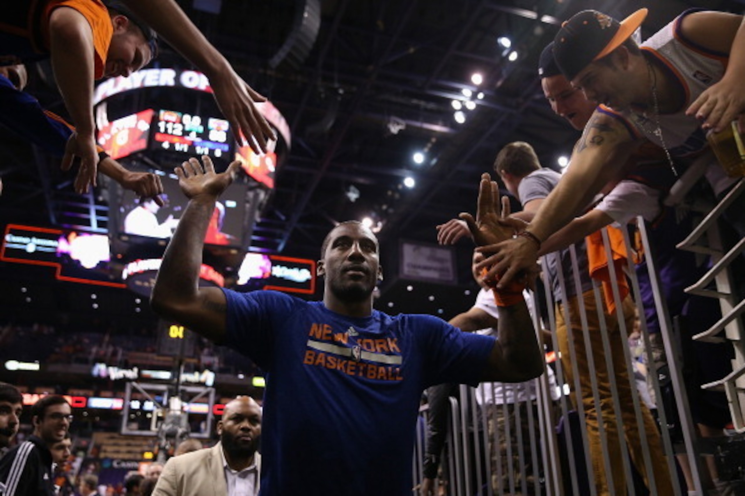PHOENIX, AZ - MARCH 28:  Amar'e Stoudemire #1 of the New York Knicks high fives fans as he walks off the court following the NBA game against the Phoenix Suns at US Airways Center on March 28, 2014 in Phoenix, Arizona.  The Suns defeated the Knicks 112-88