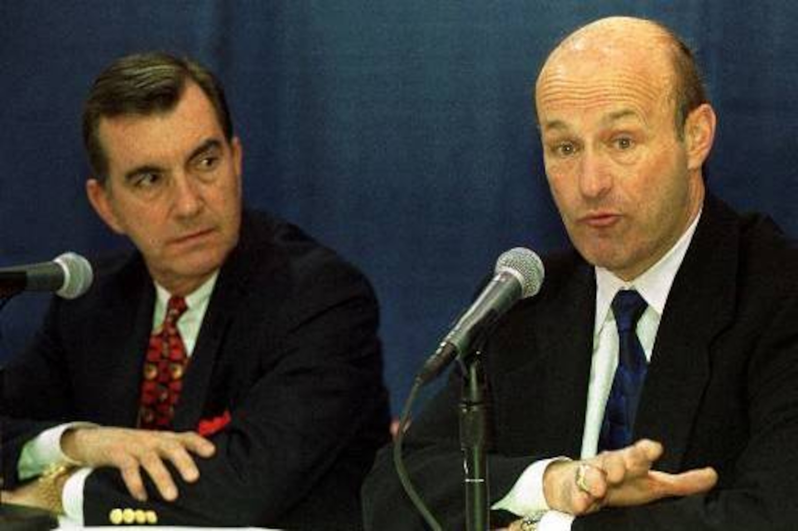 Braves president Stan Kasten (right, with GM John Schuerholz) addresses the media in January 2000, after Bud Selig suspended Rocker.
