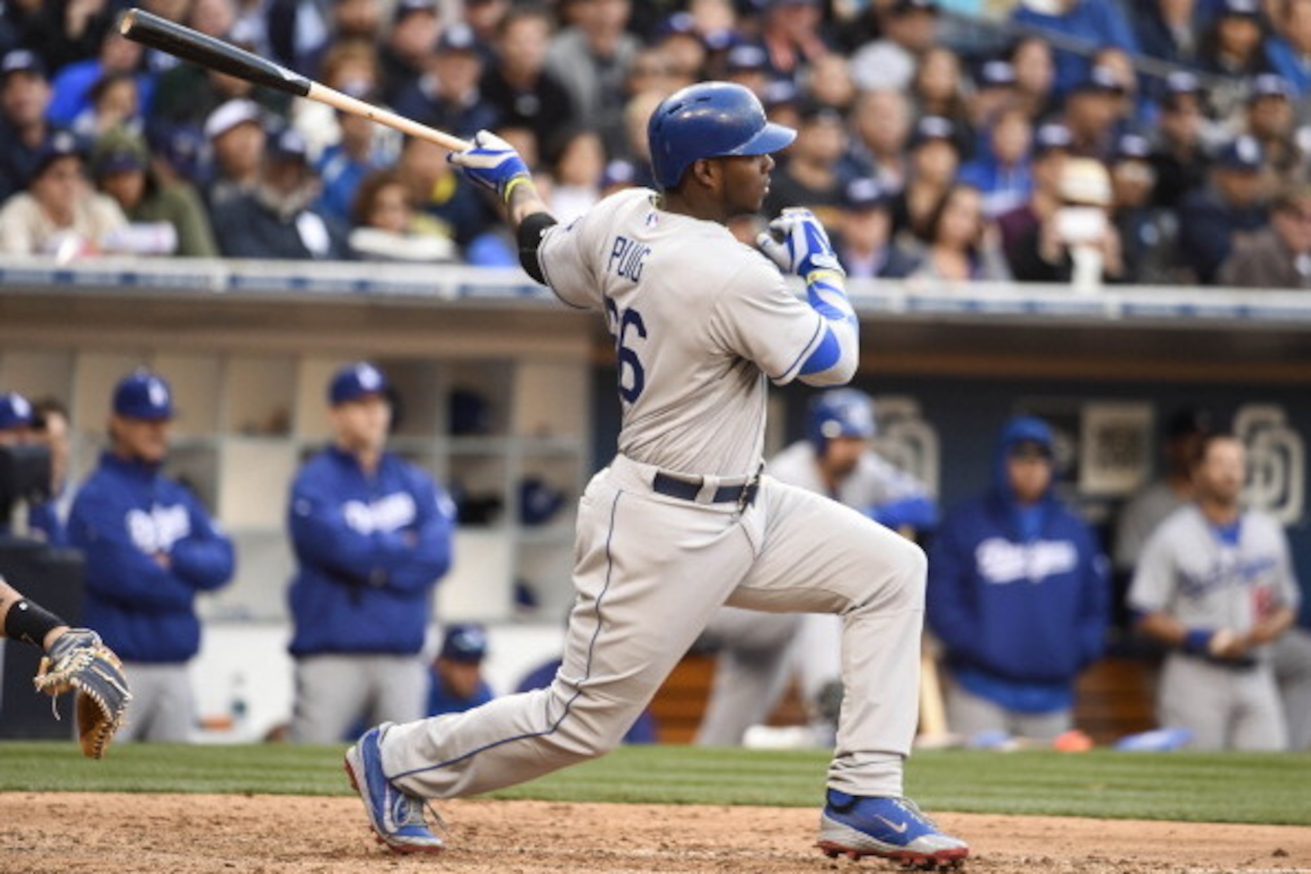 SAN DIEGO, CA - APRIL 1:  Yasiel Puig #66 of the Los Angeles Dodgers hits a single during the seventh inning of a baseball game against the San Diego Padres on Opening Day at Petco Park April 1, 2014 in San Diego, California.  (Photo by Denis Poroy/Getty 