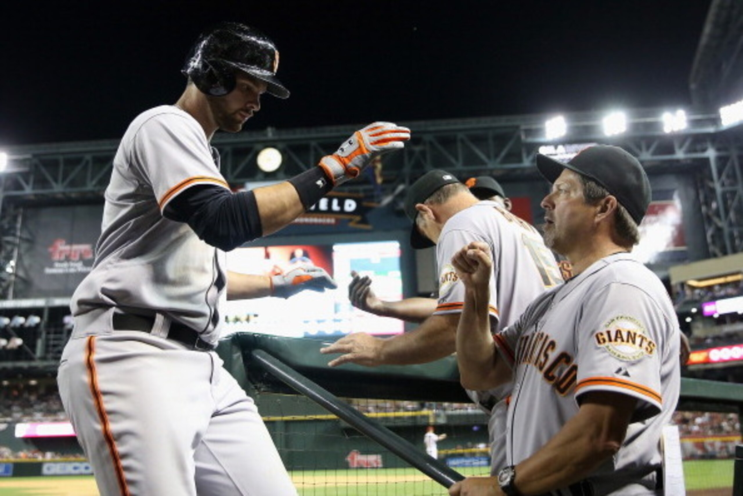 PHOENIX, AZ - MARCH 31:  Brandon Belt #9 of the San Francisco Giants high fives assistant hitting coach Joe Lefebvre #5 after Belt hits a solo home run against the Arizona Diamondbacks during the sixth inning of the Opening Day MLB game at Chase Field on 