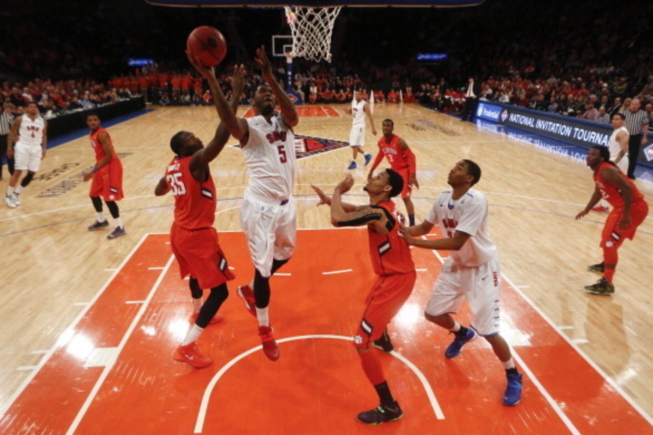 NEW YORK, NY - APRIL 1:   Markus Kennedy #5 of the Southern Methodist Mustangs drives by Landry Nnoko #35 of the Clemson Tigers during the NIT Championship semifinals at Madison Square Garden on April 1, 2014 in New York City.  (Photo by Jeff Zelevansky/G