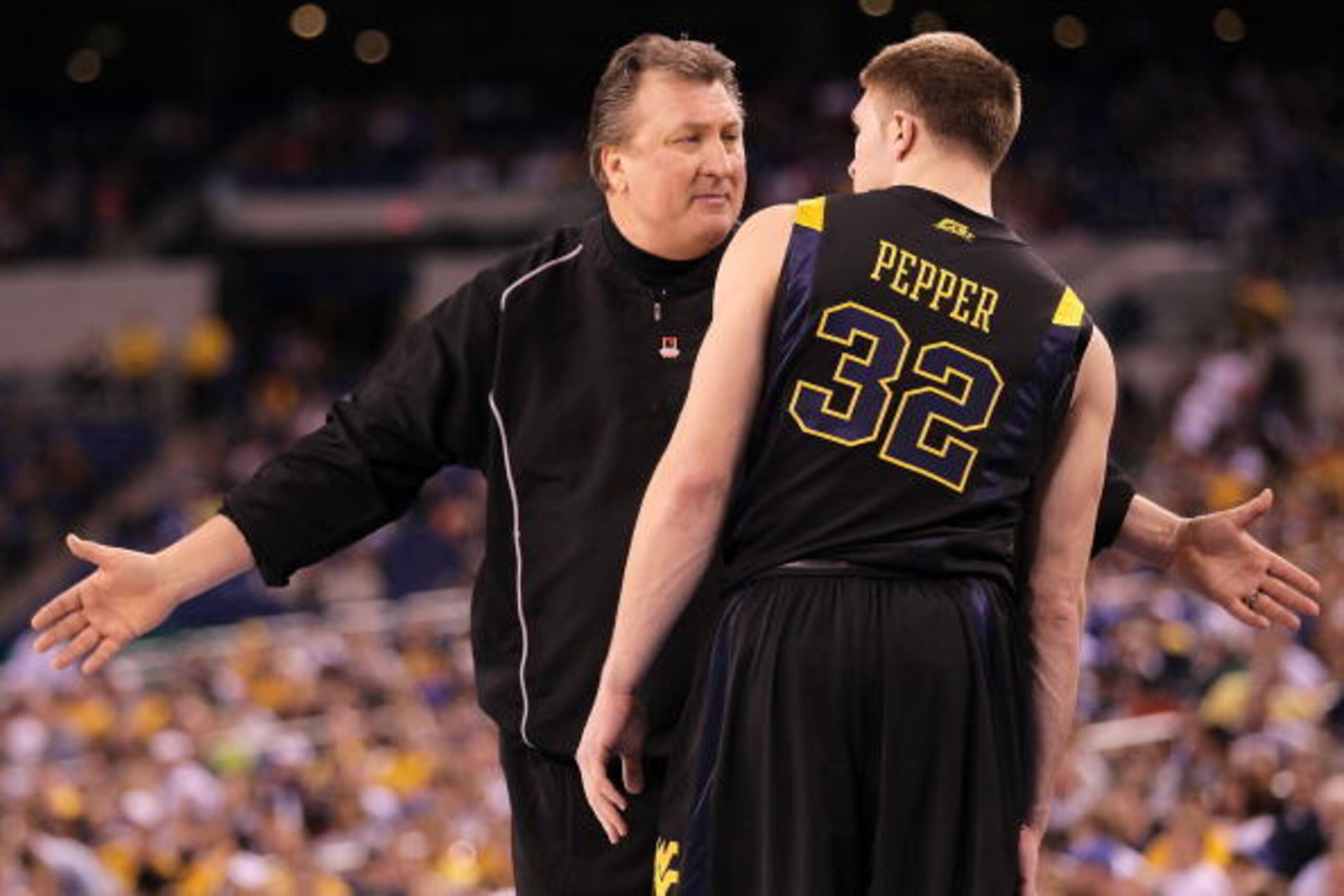 INDIANAPOLIS - APRIL 03:  Head coach Bob Huggins of the West Virginia Mountaineers talks with Dalton Pepper #32 while taking on the Duke Blue Devils during the National Semifinal game of the 2010 NCAA Division I Men's Basketball Championship at Lucas Oil 
