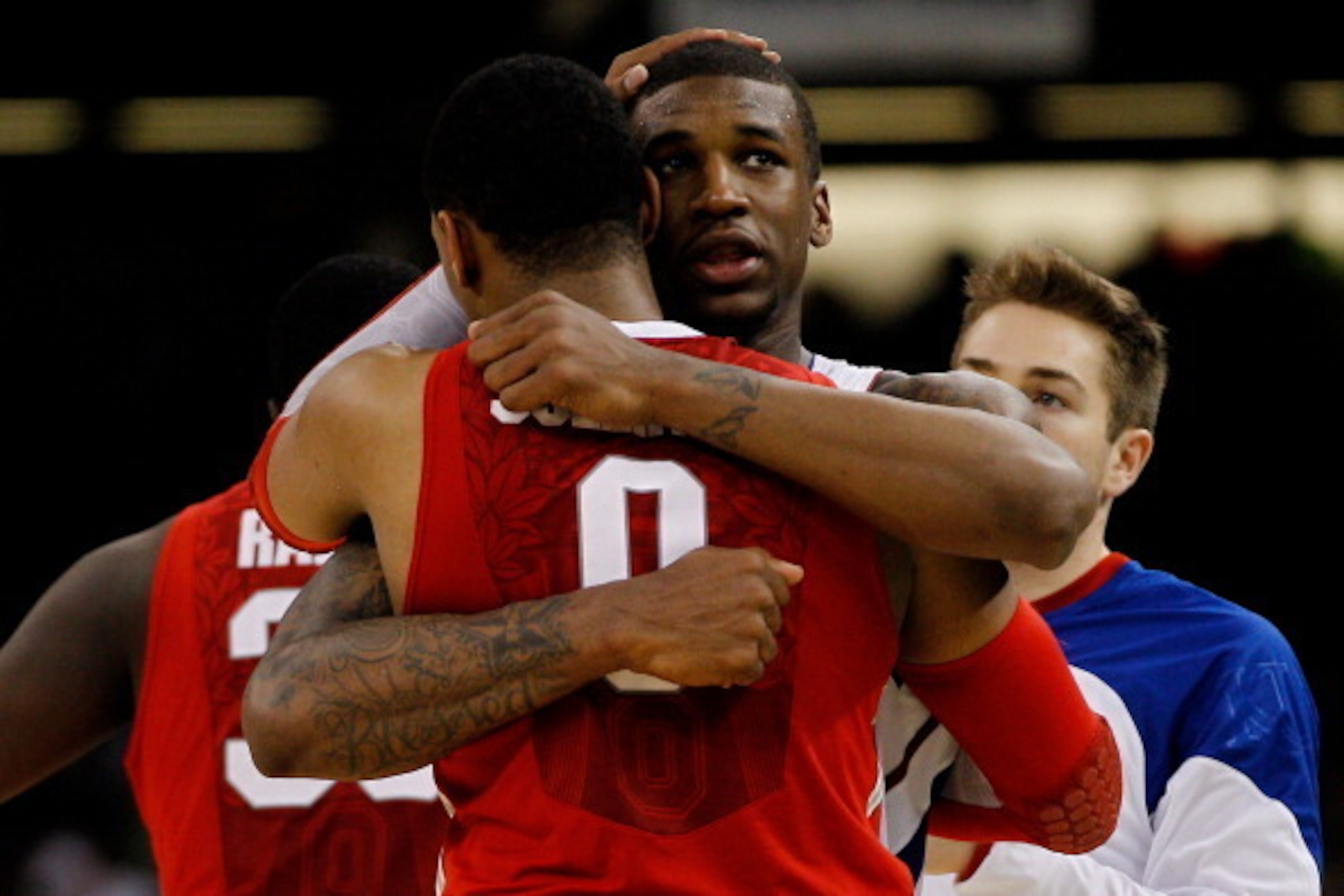 NEW ORLEANS, LA - MARCH 31:  Jared Sullinger #0 of the Ohio State Buckeyes hugs Thomas Robinson #0 of the Kansas Jayhawks after losing 64-62 in the National Semifinal game of the 2012 NCAA Division I Men's Basketball Championship at the Mercedes-Benz Supe