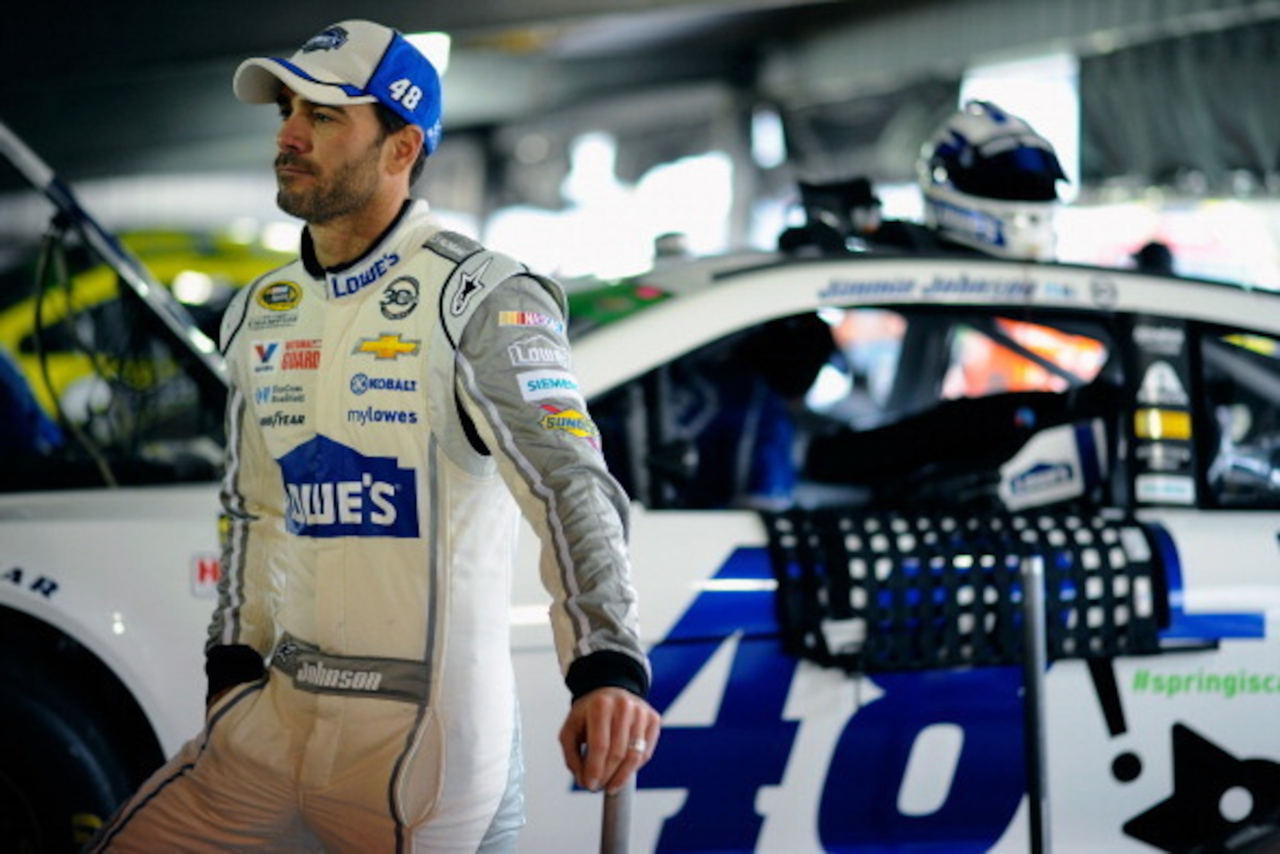 MARTINSVILLE, VA - MARCH 29: Jimmie Johnson, driver of the #48 Lowe's Chevrolet, looks on in the garage area during a rain delay in practice for the NASCAR Sprint Cup Series STP 500 at Martinsville Speedway on March 29, 2014 in Martinsville, Virginia. ( MARTINSVILLE, VA - MARCH 29: Jimmie Johnson, driver of the #48 Lowe's Chevrolet, looks on in the garage area during a rain delay in practice for the NASCAR Sprint Cup Series STP 500 at Martinsville Speedway on March 29, 2014 in Martinsville, Virginia. (