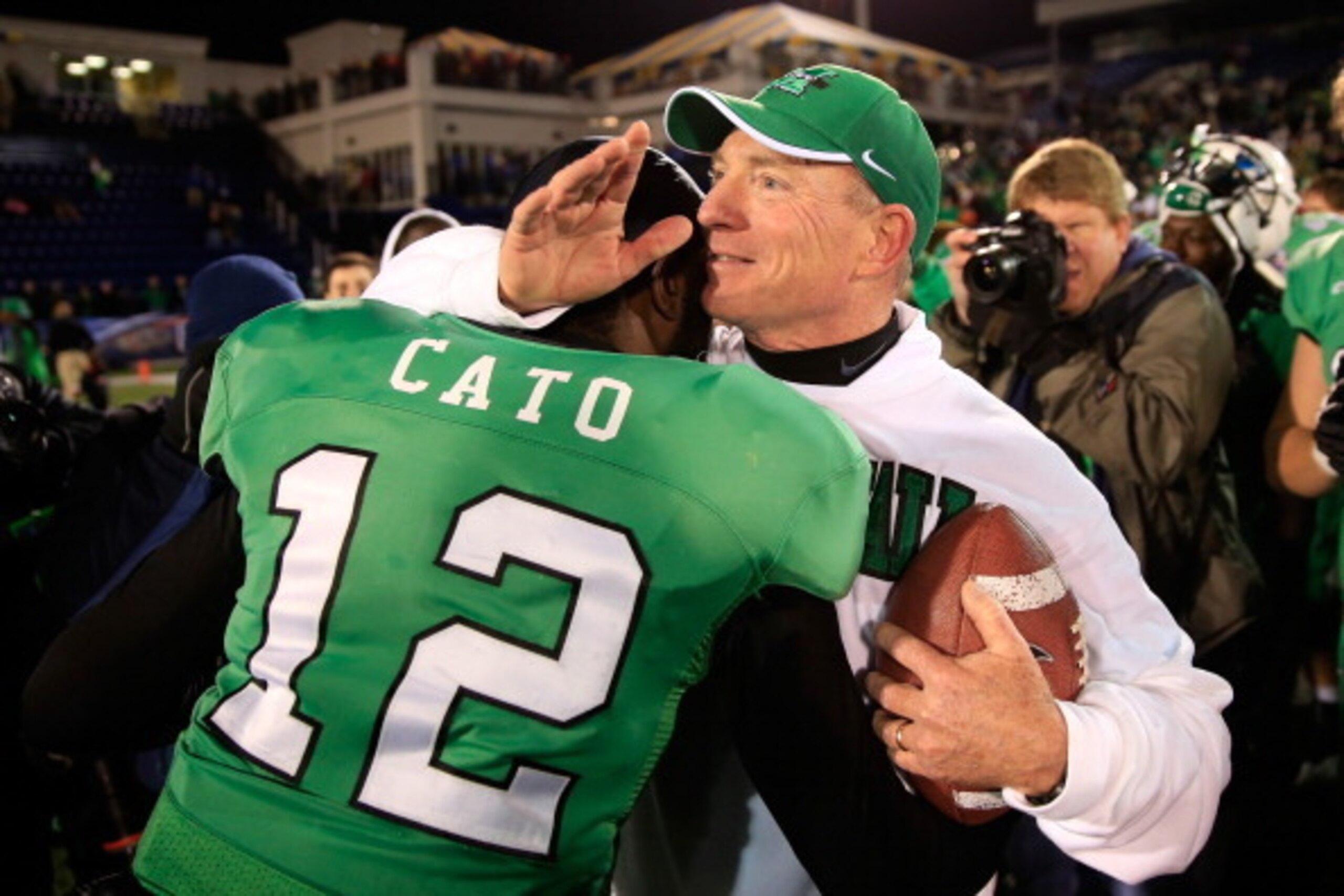 ANNAPOLIS, MD - DECEMBER 27: Quarterback Rakeem Cato #12 of the Marshall Thundering Herd hugs head coach Doc Holliday after the Herd defeated the Maryland Terrapins 31-20 to win the 2013 Military Bowl at Navy Marine Corps Memorial Stadium on December 27, 