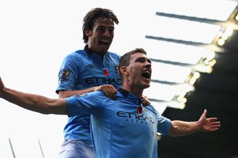 MANCHESTER, ENGLAND - NOVEMBER 11:  Edin Dzeko of Manchester City celebrates scoring his team's second goal with team-mate David Silva (L) during the Barclays Premier League match between Manchester City and Tottenham Hotspur at the Etihad Stadium on Nove