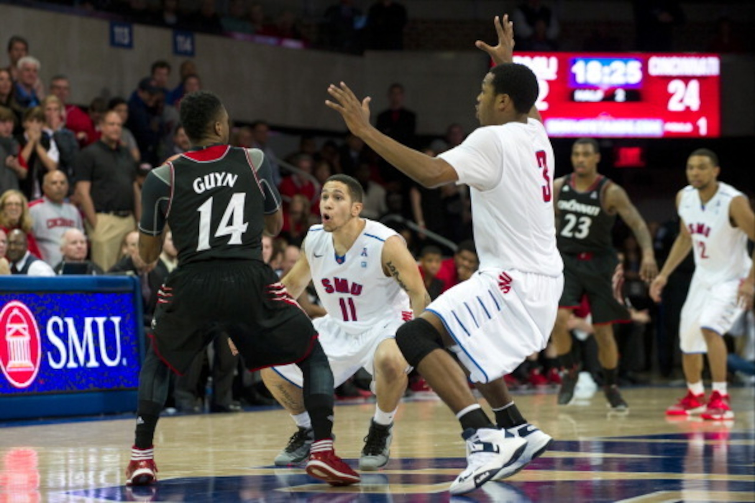 DALLAS, TX - FEBRUARY 8: Nic Moore #11 and Sterling Brown #3 of the SMU Mustangs trap Ge'Lawn Guyn #14 the Cincinnati Bearcats on February 8, 2014 at Moody Coliseum in Dallas, Texas. (Photo by Cooper Neill/Getty Images) DALLAS, TX - FEBRUARY 8: Nic Moore #11 and Sterling Brown #3 of the SMU Mustangs trap Ge'Lawn Guyn #14 the Cincinnati Bearcats on February 8, 2014 at Moody Coliseum in Dallas, Texas. (Photo by Cooper Neill/Getty Images)