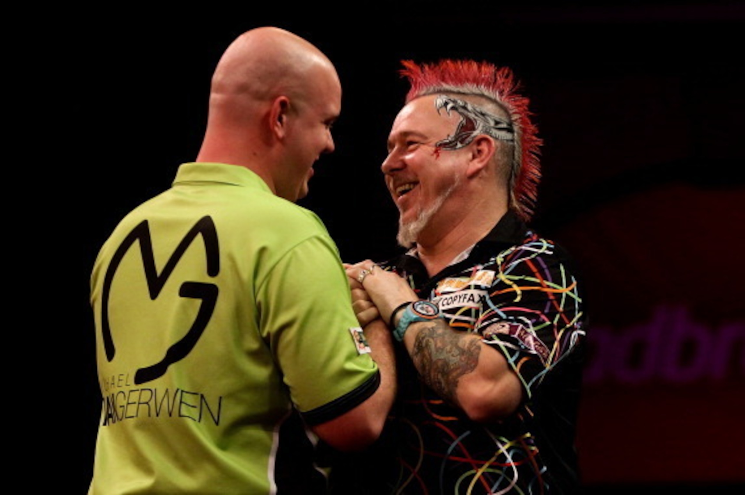 LONDON, ENGLAND - JANUARY 01: Peter Wright of Scotland congratulates Michael van Gerwen of The Netherlands during the final of the Ladbrokes.com World Darts Championships at Alexandra Palace on January 1, 2014 in London, England.  (Photo by Ben Hoskins/Ge