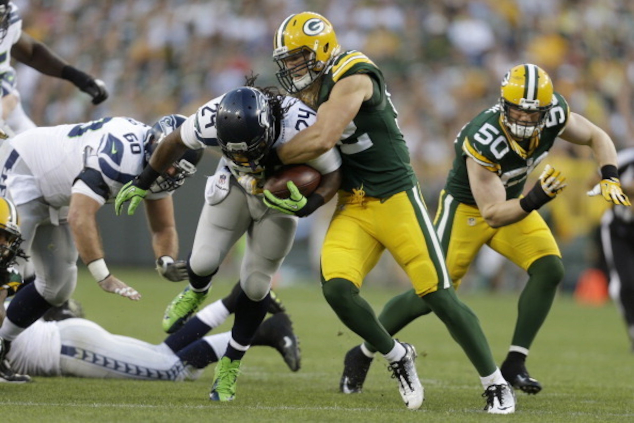 GREEN BAY, WI - AUGUST 23: Marshawn Lynch #24 of the Seattle Seahawks gets tackled by Clay Matthews #52 of the Green Bay Packers during a preseason game at Lambeau Field on August 23, 2013 in Green Bay, Wisconsin. (Photo by Mike McGinnis/Getty Images) GREEN BAY, WI - AUGUST 23: Marshawn Lynch #24 of the Seattle Seahawks gets tackled by Clay Matthews #52 of the Green Bay Packers during a preseason game at Lambeau Field on August 23, 2013 in Green Bay, Wisconsin. (Photo by Mike McGinnis/Getty Images)