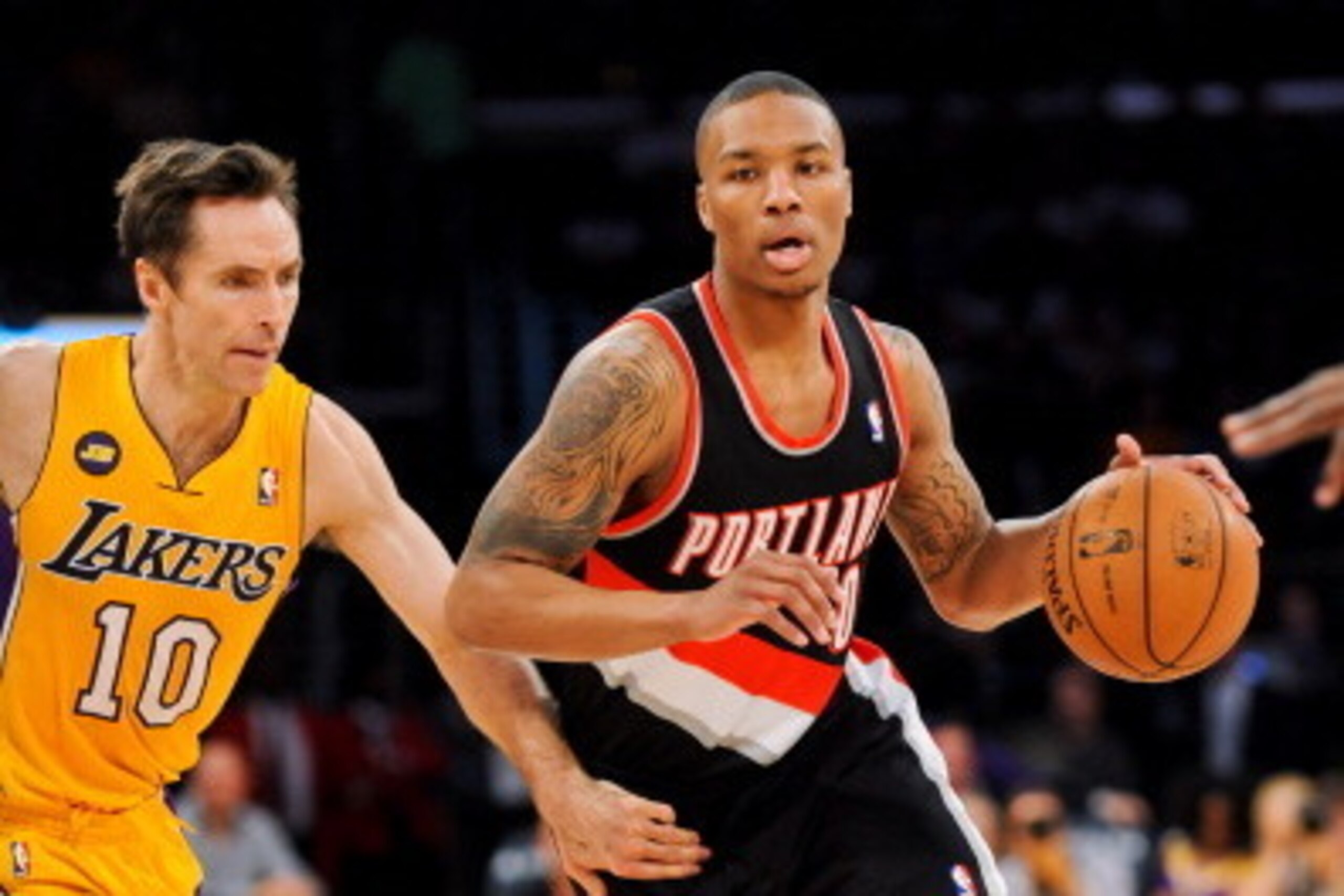 LOS ANGELES, CA - FEBRUARY 22: Damian Lillard #0 of the Portland Trail Blazers drives against Steve Nash #10 of the Los Angeles Lakers at Staples Center on February 22, 2013 in Los Angeles, California. NOTE TO USER: User expressly acknowledges and agrees 