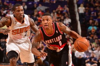PHOENIX, AZ - OCTOBER 30: Damian Lillard #0 of the Portland Trailblazers drives against Eric Bledsoe #2 of the Phoenix Suns on October 30, 2013 at U.S. Airways Center in Phoenix, Arizona. NOTE TO USER: User expressly acknowledges and agrees that, by downl