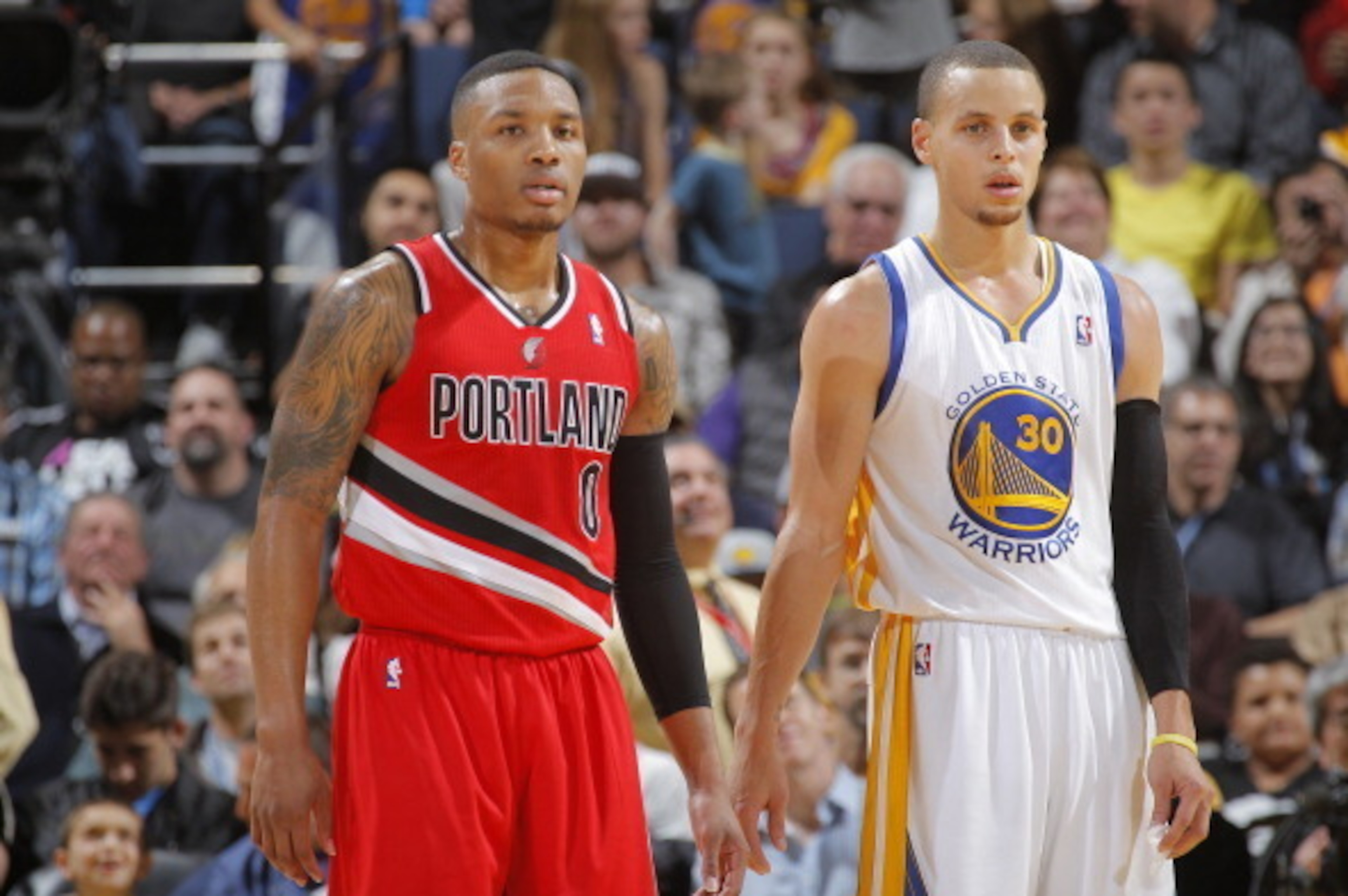 OAKLAND, CA - JANUARY 26: Damian Lillard #0 of the Portland Trail Blazers faces off against Stephen Curry #30 of the Golden State Warriors on January 26, 2014 at Oracle Arena in Oakland, California. NOTE TO USER: User expressly acknowledges and agrees tha OAKLAND, CA - JANUARY 26: Damian Lillard #0 of the Portland Trail Blazers faces off against Stephen Curry #30 of the Golden State Warriors on January 26, 2014 at Oracle Arena in Oakland, California. NOTE TO USER: User expressly acknowledges and agrees tha