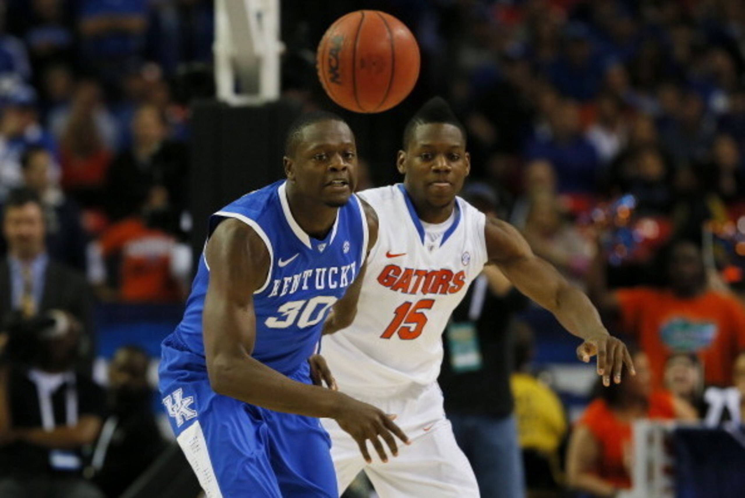 ATLANTA, GA - MARCH 16:  Will Yeguete #15 of the Florida Gators knocks the ball away from Julius Randle #30 of the Kentucky Wildcats in the first half during the Championship game of the 2014 Men's SEC Basketball Tournament at Georgia Dome on March 16, 20