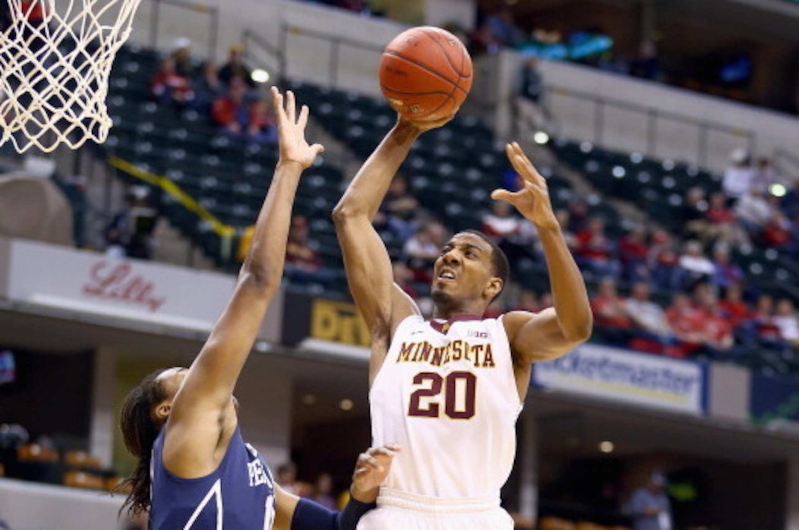 INDIANAPOLIS, IN - MARCH 13:  Austin Hollins #20 of the Minnesota Golden Gophers shoots the ball in the game against the Penn State  Nittany Lions during the first round of the Big Ten Basketball Tournament at Bankers Life Fieldhouse on March 13, 2014 in 
