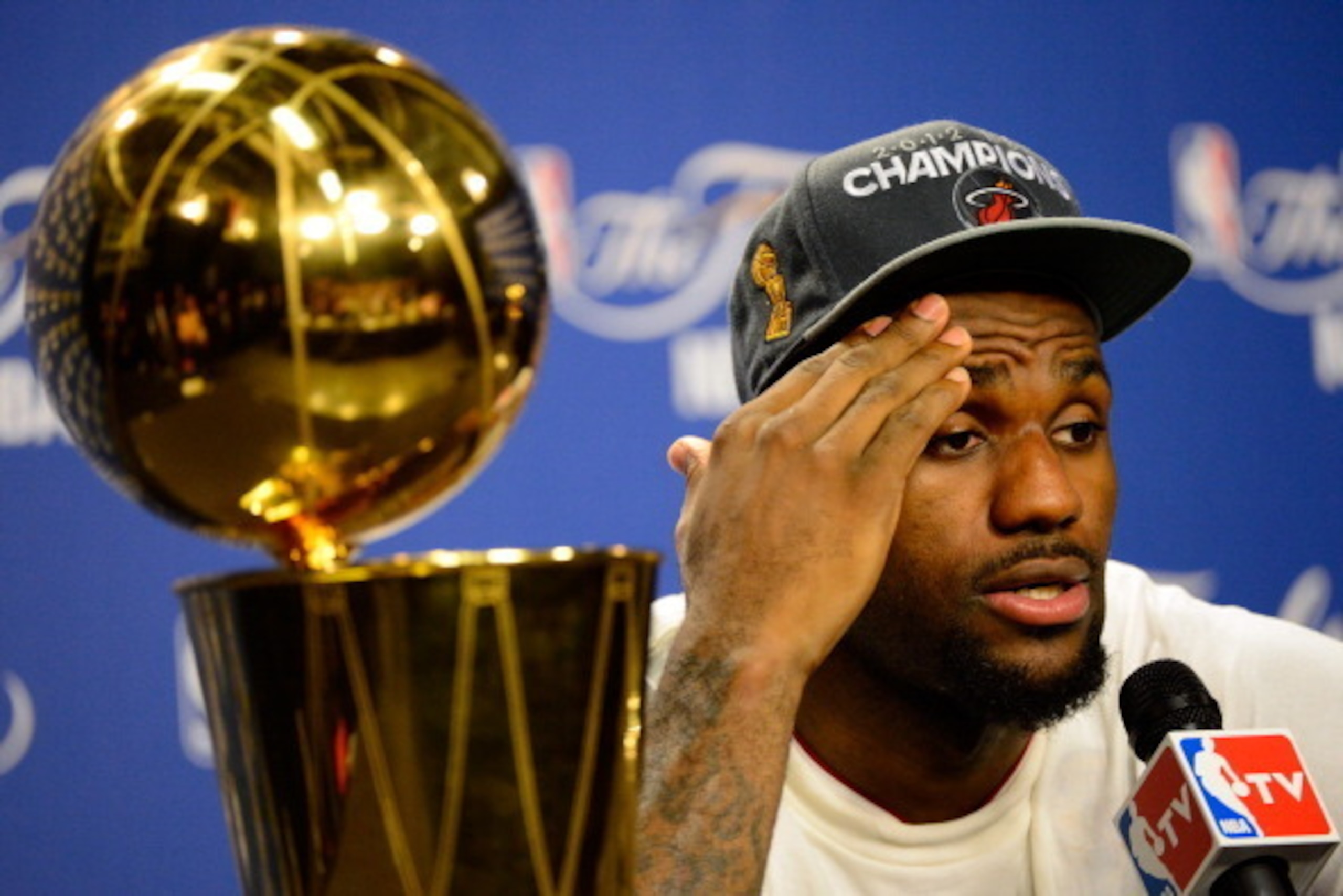 MIAMI, FL - JUNE 21:  LeBron James #6 of the Miami Heat answers questions from the media next to the Larry O'Brien Finals Championship trophy during his post game press conference after they won 121-106 against the Oklahoma City Thunder in Game Five of th