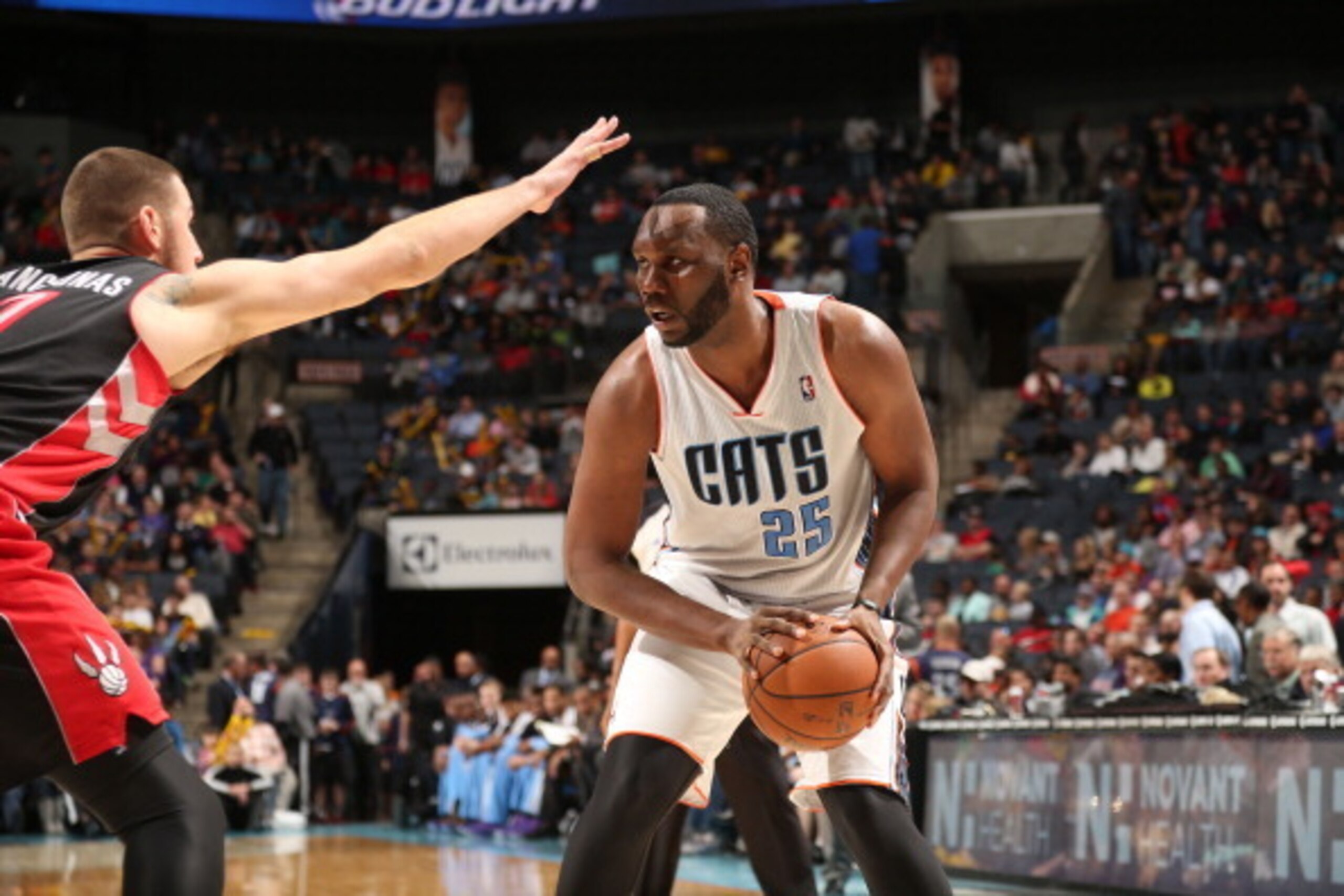 CHARLOTTE, NC - JANUARY 20:  Al Jefferson #25 of the Charlotte Bobcats controls the ball against Jonas Valanciunas #17 of the Toronto Raptors during the game at the Time Warner Cable Arena on January 20, 2014 in Charlotte, North Carolina.  NOTE TO USER: U