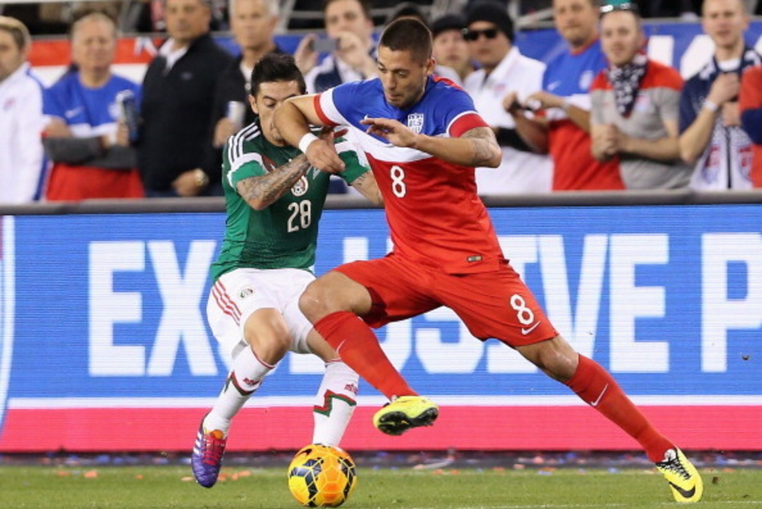 GLENDALE, AZ - APRIL 02:  Clint Dempsey #8 of USA controls the ball under pressure from Rogelio Alfredo Chavez #28 of Mexico during the first half of the International Friendly against Mexico at University of Phoenix Stadium on April 2, 2014 in Glendale, 