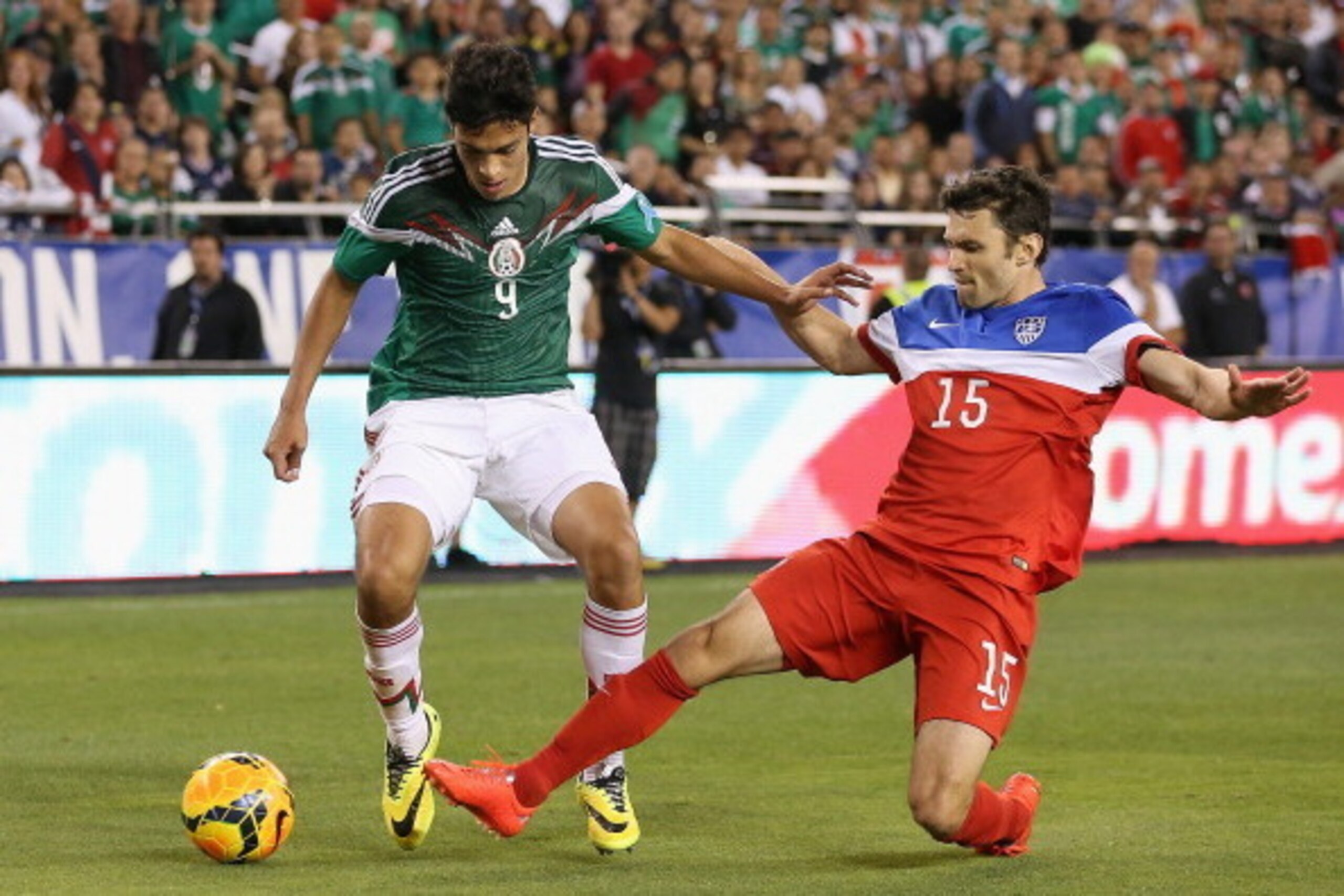 GLENDALE, AZ - APRIL 02:  Raul Jimenez #9 of Mexico controls the ball under pressure from Michael Parkhurst #15 of USA during the second half of the International Friendly at University of Phoenix Stadium on April 2, 2014 in Glendale, Arizona. Mexico and 