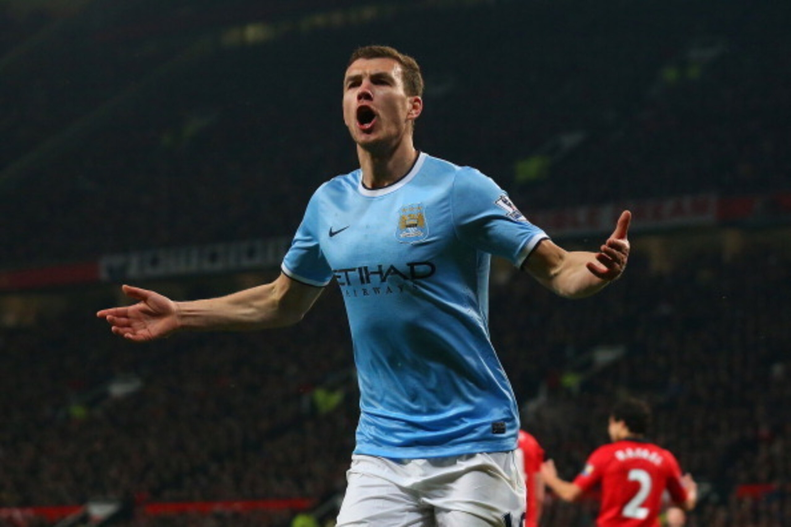 MANCHESTER, ENGLAND - MARCH 25:  Edin Dzeko of Manchester City celebrates scoring the second goal during the Barclays Premier League match between Manchester United and Manchester City at Old Trafford on March 25, 2014 in Manchester, England.  (Photo by A