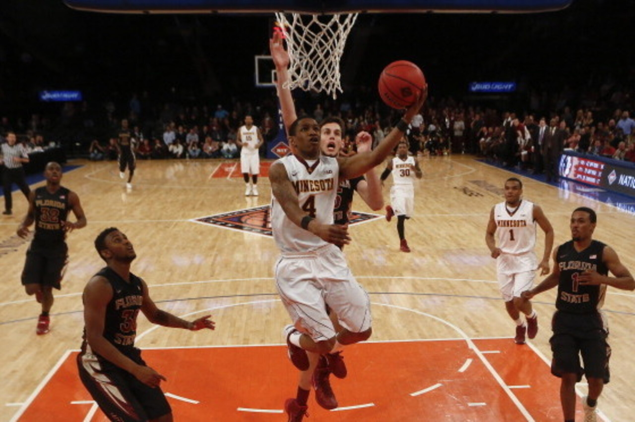 NEW YORK, NY - APRIL 1:  Deandre Mathieu #4 of the Minnesota Golden Gophers drives by Boris Bojanovsky #15 of the Florida State Seminoles during the NIT Championship semifinals at Madison Square Garden on April 1, 2014 in New York City.  (Photo by Jeff Ze