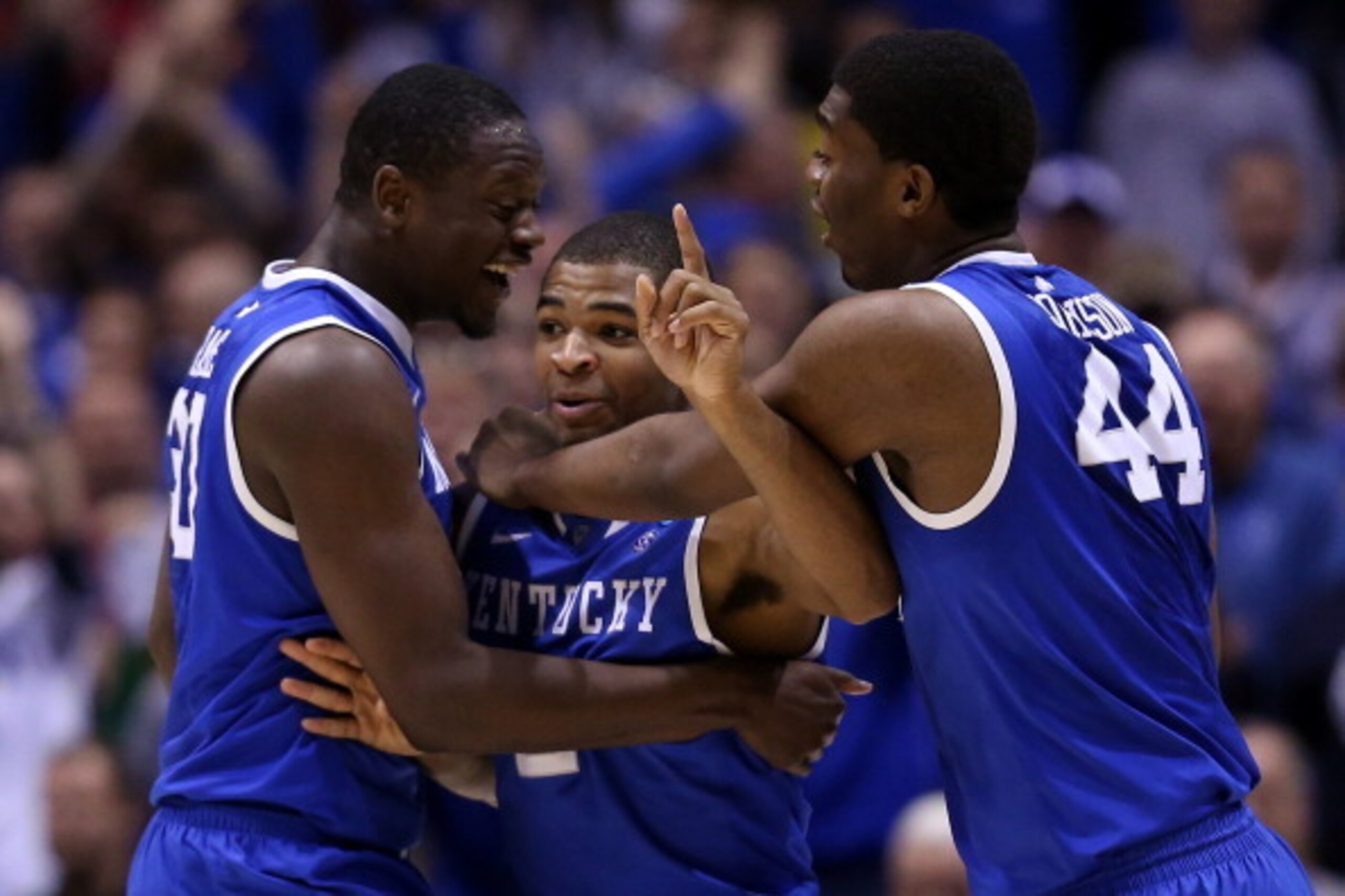 INDIANAPOLIS, IN - MARCH 30: Aaron Harrison #2 of the Kentucky Wildcats celebrates with teammates Julius Randle #30 and Dakari Johnson #44 after defeating the Michigan Wolverines 75 to 72 in the midwest regional final of the 2014 NCAA Men's Basketball To INDIANAPOLIS, IN - MARCH 30: Aaron Harrison #2 of the Kentucky Wildcats celebrates with teammates Julius Randle #30 and Dakari Johnson #44 after defeating the Michigan Wolverines 75 to 72 in the midwest regional final of the 2014 NCAA Men's Basketball To