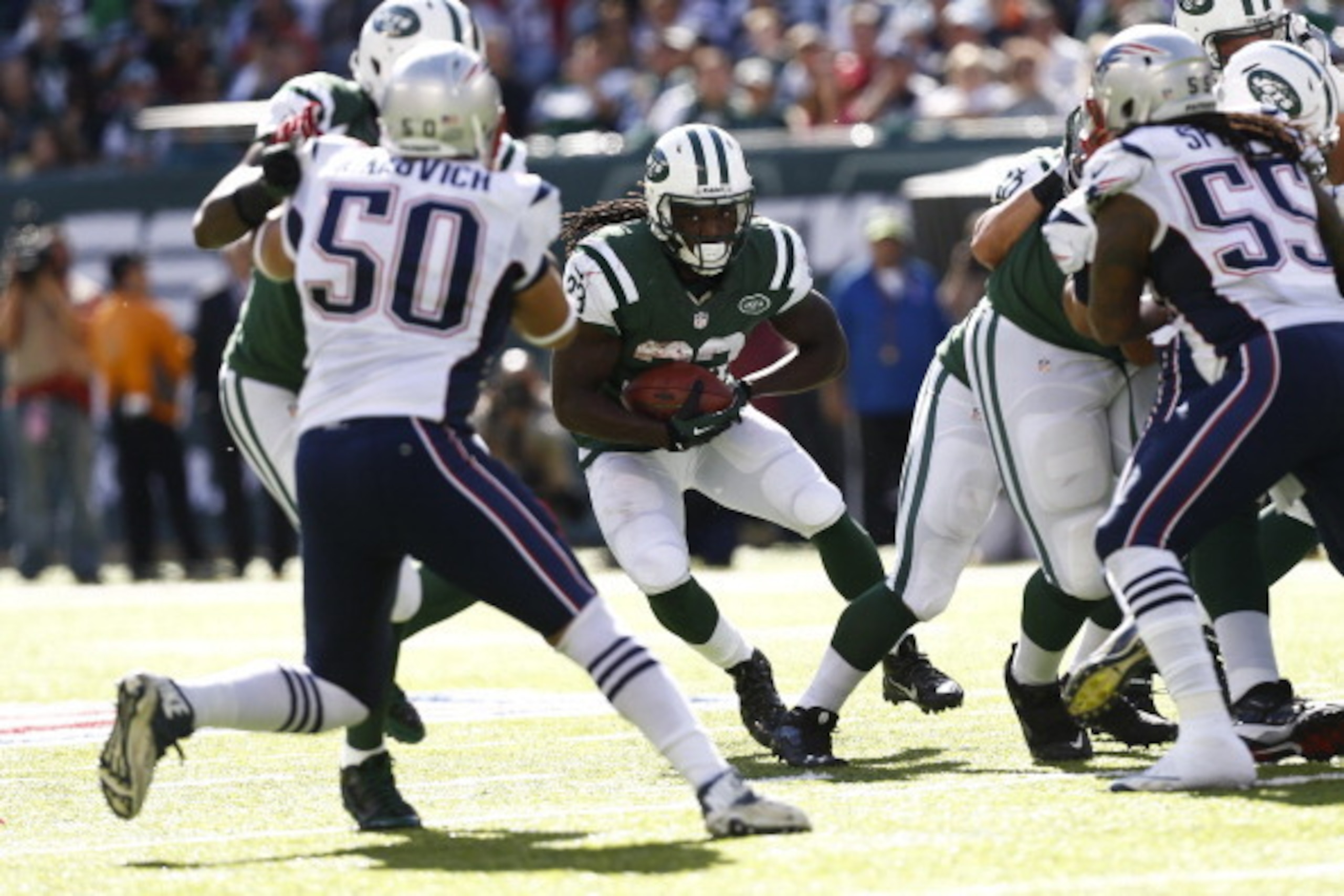 EAST RUTHERFORD, NJ - OCTOBER 20:   Mike Goodson #23 of the New York Jets runs against the New England Patriots during their game at MetLife Stadium on October 20, 2013 in East Rutherford, New Jersey.  (Photo by Jeff Zelevansky/Getty Images)