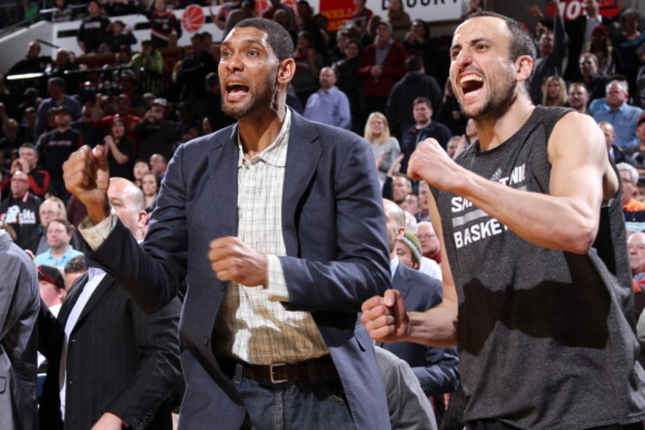 PORTLAND, OR - FEBRUARY 19:  Tim Duncan #21 and Manu Ginobili #20 of the San Antonio Spurs react to a play on the bench against the Portland Trail Blazers on February 19, 2014 at the Moda Center Arena in Portland, Oregon. NOTE TO USER: User expressly ackn