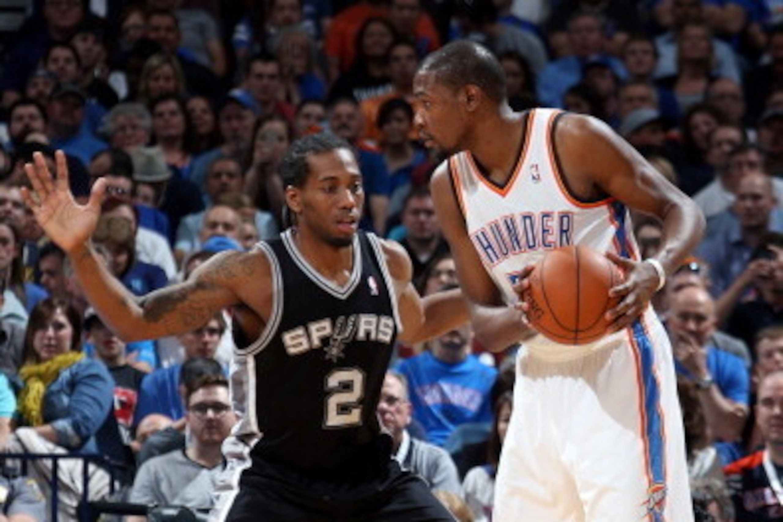 OKLAHOMA CITY, OK - APRIL 03: Kevin Durant #35 of the Oklahoma City Thunder handles the ball against Kawhi Leonard #2 of the San Antonio Spurs on April 03, 2014 at the Chesapeake Energy Arena in Oklahoma City, Oklahoma. NOTE TO USER: User expressly acknow