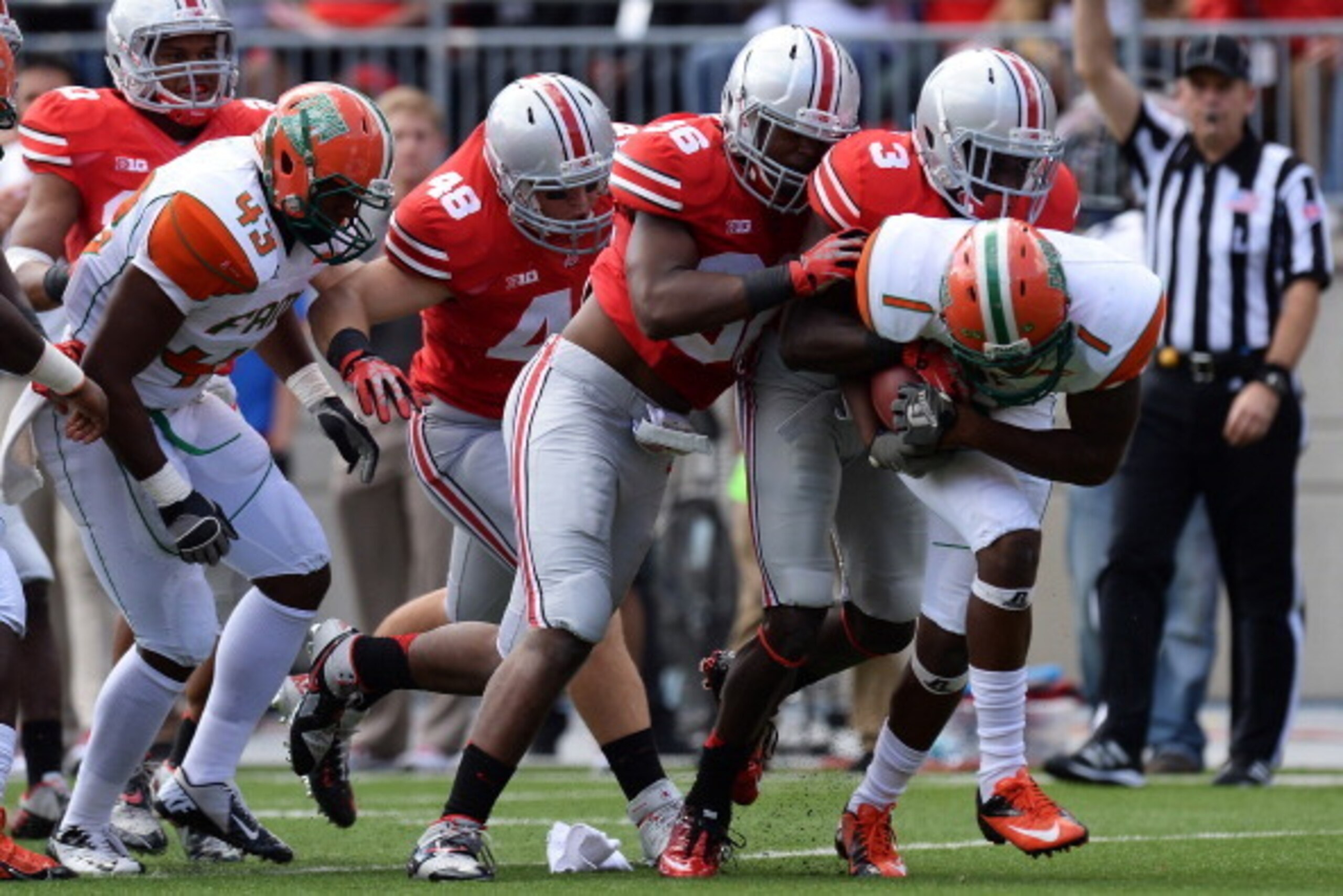 COLUMBUS, OH - SEPTEMBER 21:  Joe Burger #48 of the Ohio State Buckeyes, Trey Johnson #36 of the Ohio State Buckeyes and Corey Brown #3 of the Ohio State Buckeyes gang up to stop ballcarrier Al-Terek McBurse #1 of the Florida A&M Rattlers in the third qua