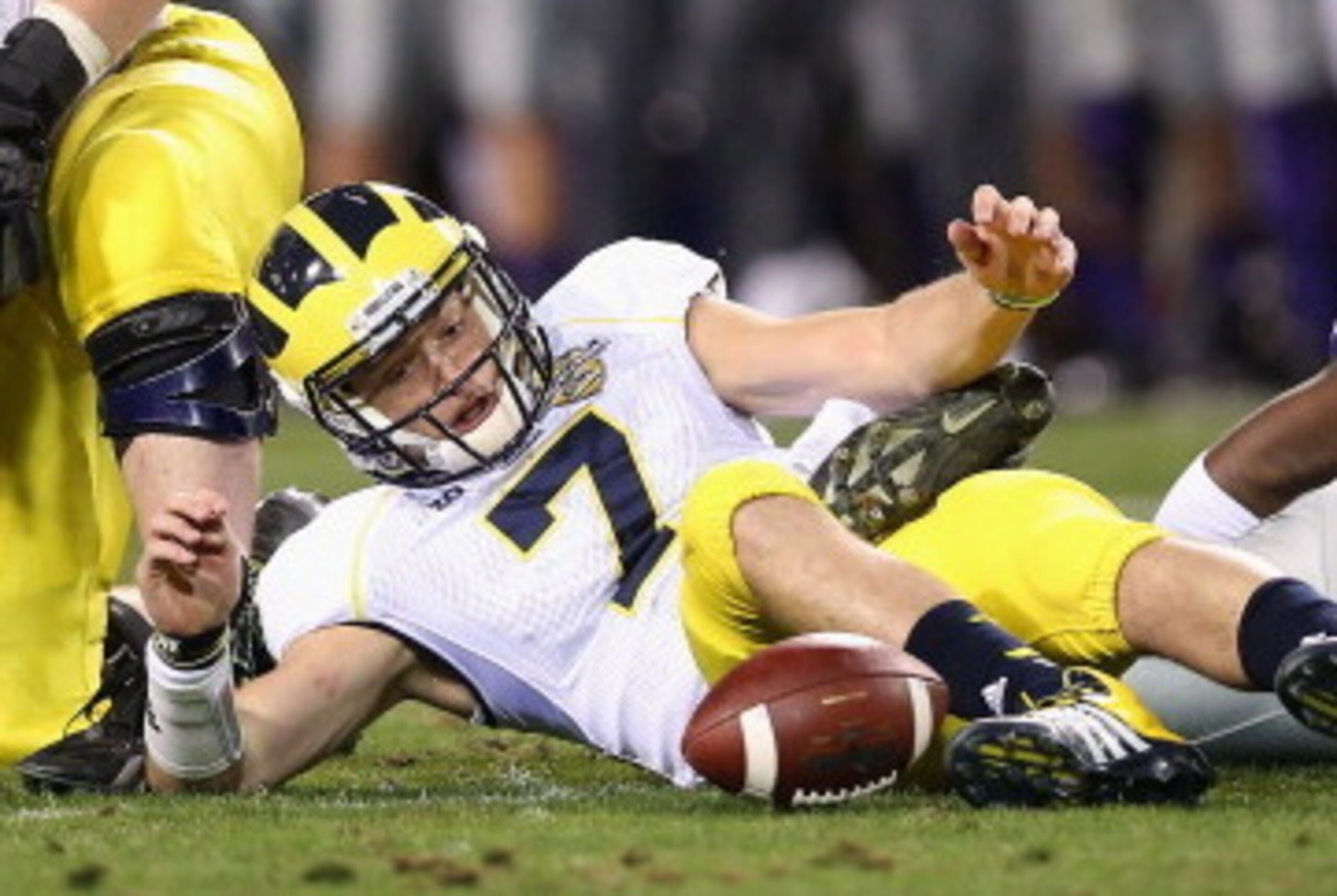 TEMPE, AZ - DECEMBER 28:  Quarterback Shane Morris #7 of the Michigan Wolverines fumbles the football during the Buffalo Wild Wings Bowl against the Kansas State Wildcats at Sun Devil Stadium on December 28, 2013 in Tempe, Arizona.  The Wildcats defeated
