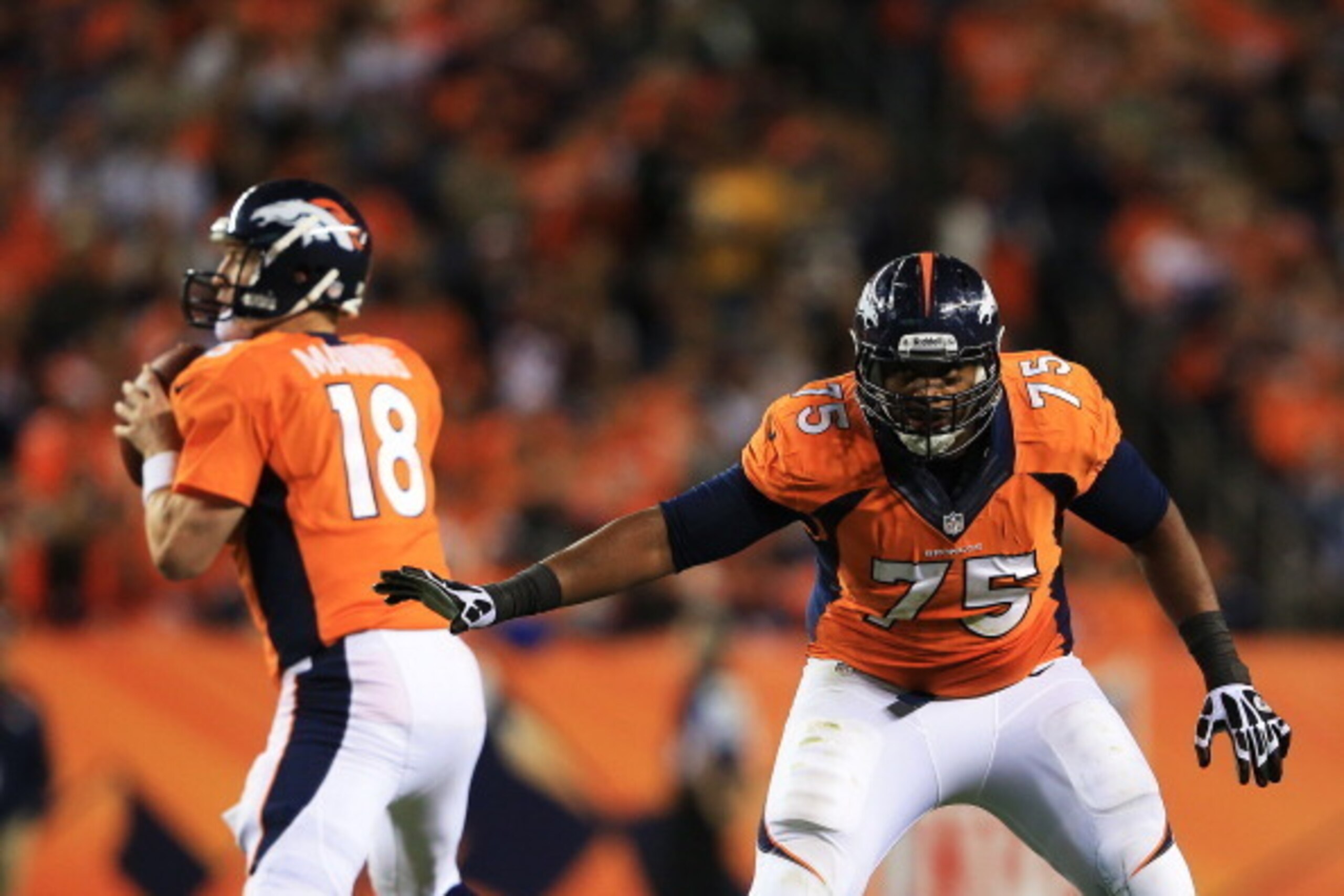 DENVER, CO - SEPTEMBER 23:  Chris Clark #75 protects  Peyton Manning #18 of the Denver Broncos in the second quarter against the Oakland Raiders at Sports Authority Field at Mile High on September 23, 2013 in Denver, Colorado.  (Photo by Doug Pensinger/Ge