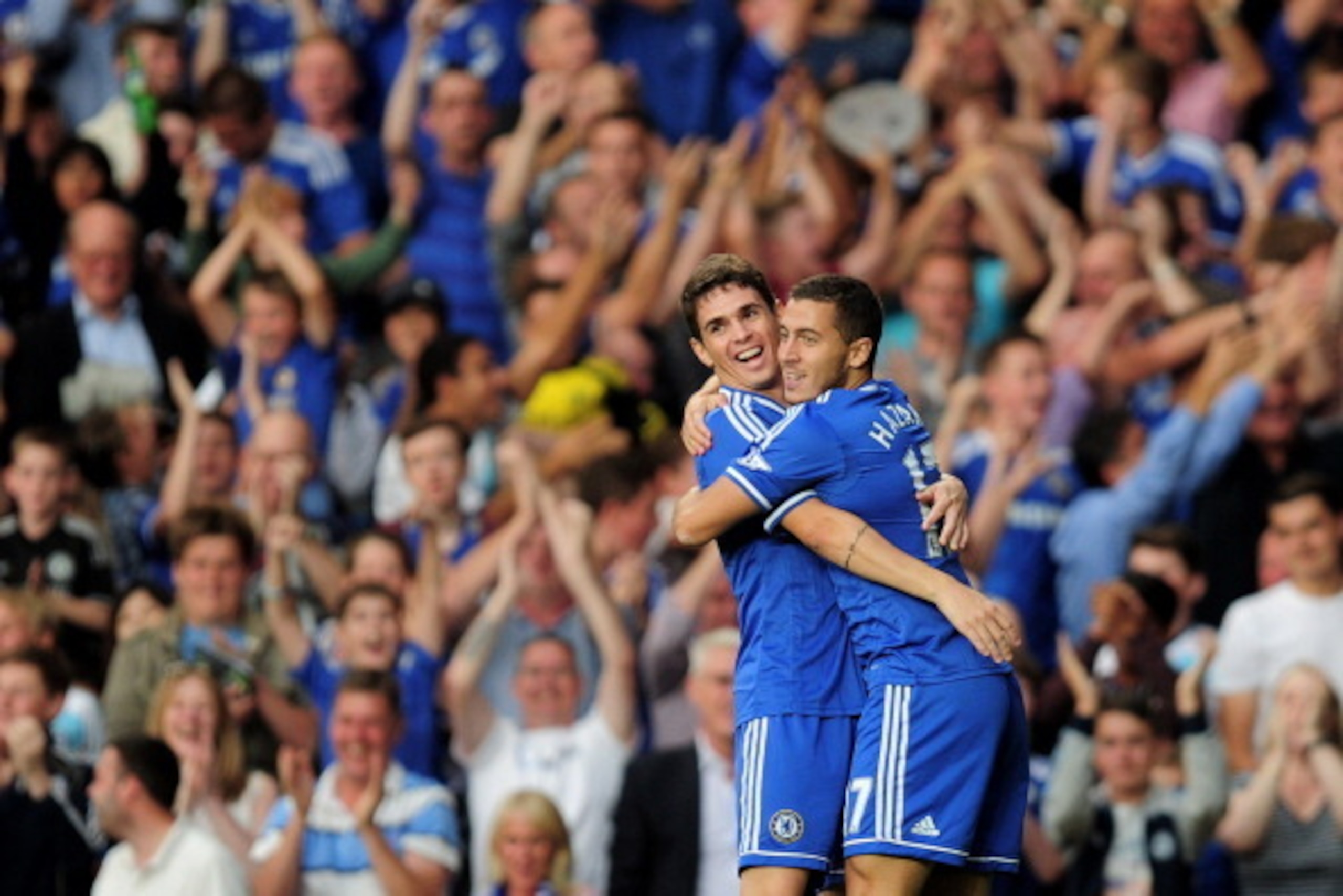 LONDON, ENGLAND - AUGUST 21:  Eden Hazard (R) of Chelsea is congratulated by teammate Oscar (L) after scoring the opening goal during the Barclays Premier League match between Chelsea and Aston Villa at Stamford Bridge on August 21, 2013 in London, Englan