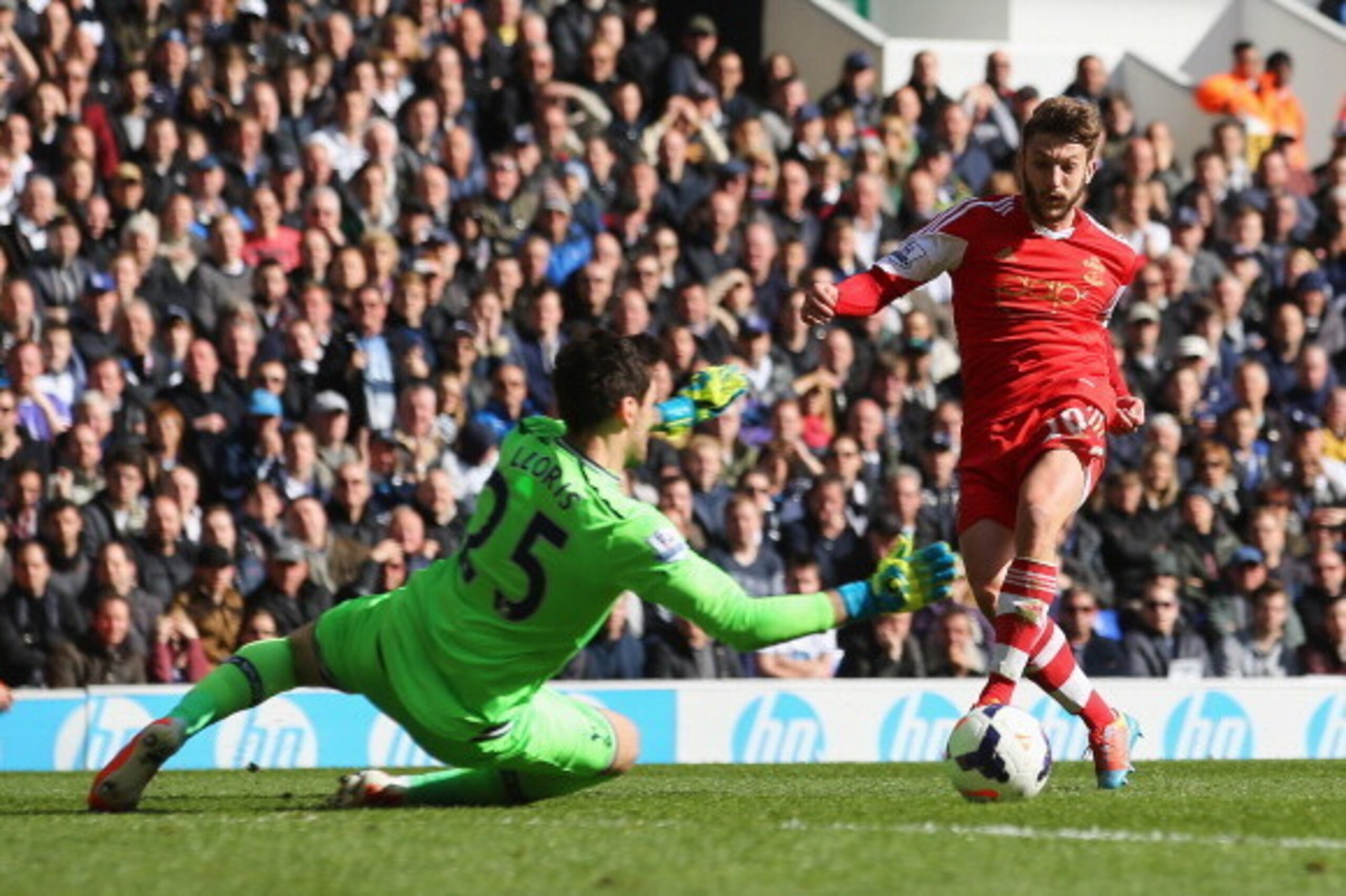 LONDON, ENGLAND - MARCH 23:  Adam Lallana of Southampton scores his team's second goal past Hugo Lloris of Tottenham Hotspur during the Barclays Premier League match between Tottenham Hotspur and Southampton at White Hart Lane on March 23, 2014 in London,