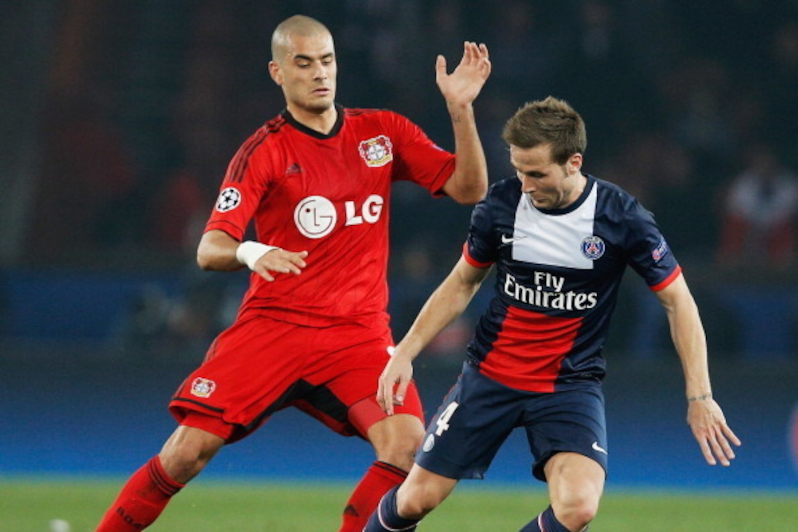 PARIS, FRANCE - MARCH 12: Yohan Cabaye of Paris Saint-Germain evades Eren Derdiyok of Bayer Leverkusen during the UEFA Champions League Round of 16 second leg match between Paris Saint-Germain FC and Bayer Leverkusen at Parc des Princes on March 12, 2014 PARIS, FRANCE - MARCH 12: Yohan Cabaye of Paris Saint-Germain evades Eren Derdiyok of Bayer Leverkusen during the UEFA Champions League Round of 16 second leg match between Paris Saint-Germain FC and Bayer Leverkusen at Parc des Princes on March 12, 2014