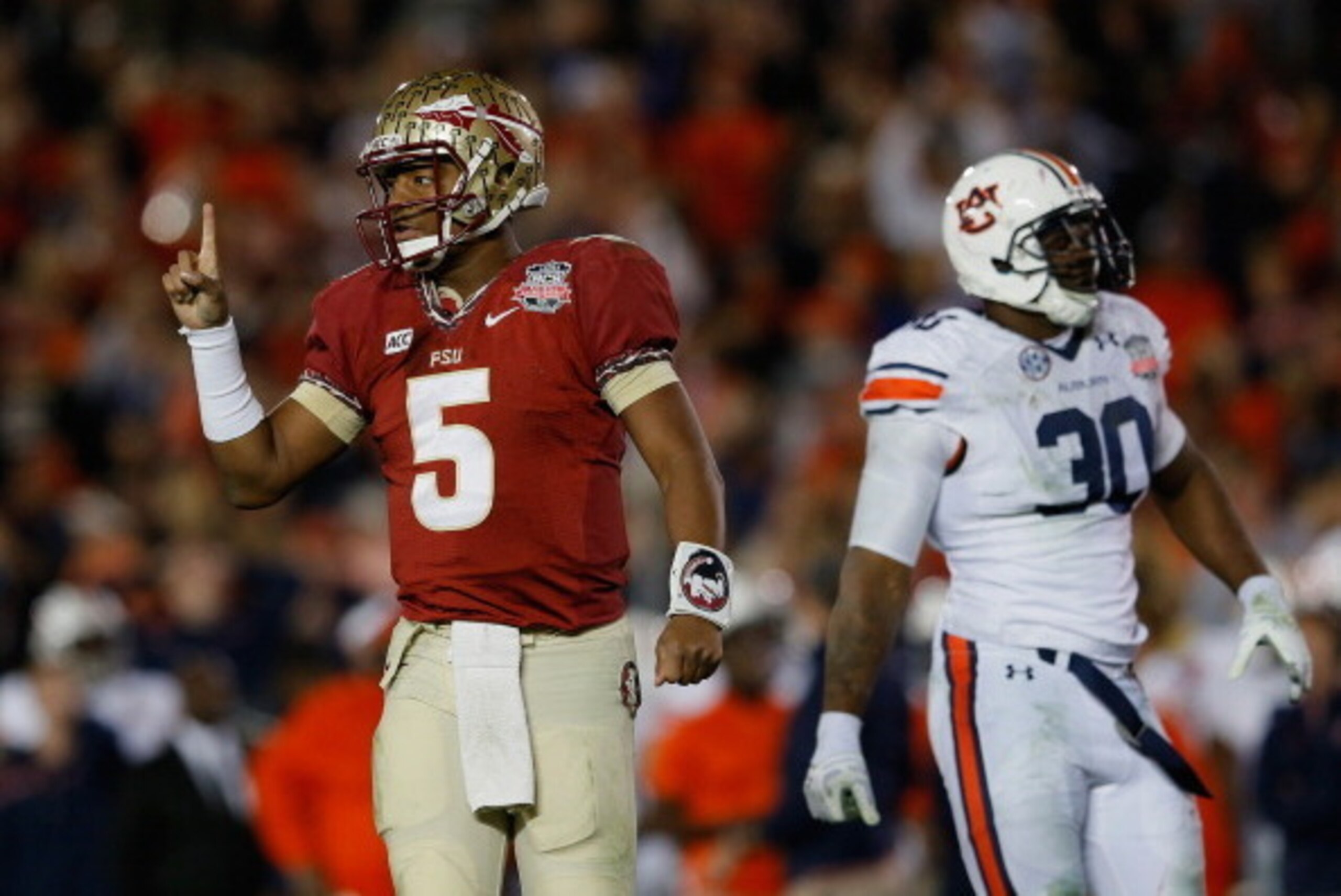 PASADENA, CA - JANUARY 06:  Quarterback Jameis Winston #5 of the Florida State Seminoles signals during the 2014 Vizio BCS National Championship Game against the Auburn Tigers at the Rose Bowl on January 6, 2014 in Pasadena, California.  (Photo by Kevin C