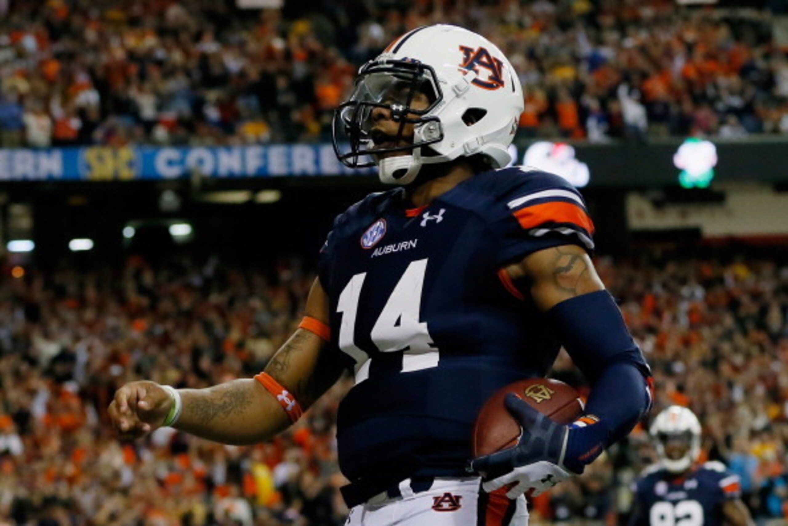 ATLANTA, GA - DECEMBER 07:  Quarterback Nick Marshall #14 of the Auburn Tigers celebrates scoring a touchdown in the first quarter against the Missouri Tigers during the SEC Championship Game at Georgia Dome on December 7, 2013 in Atlanta, Georgia.  (Phot