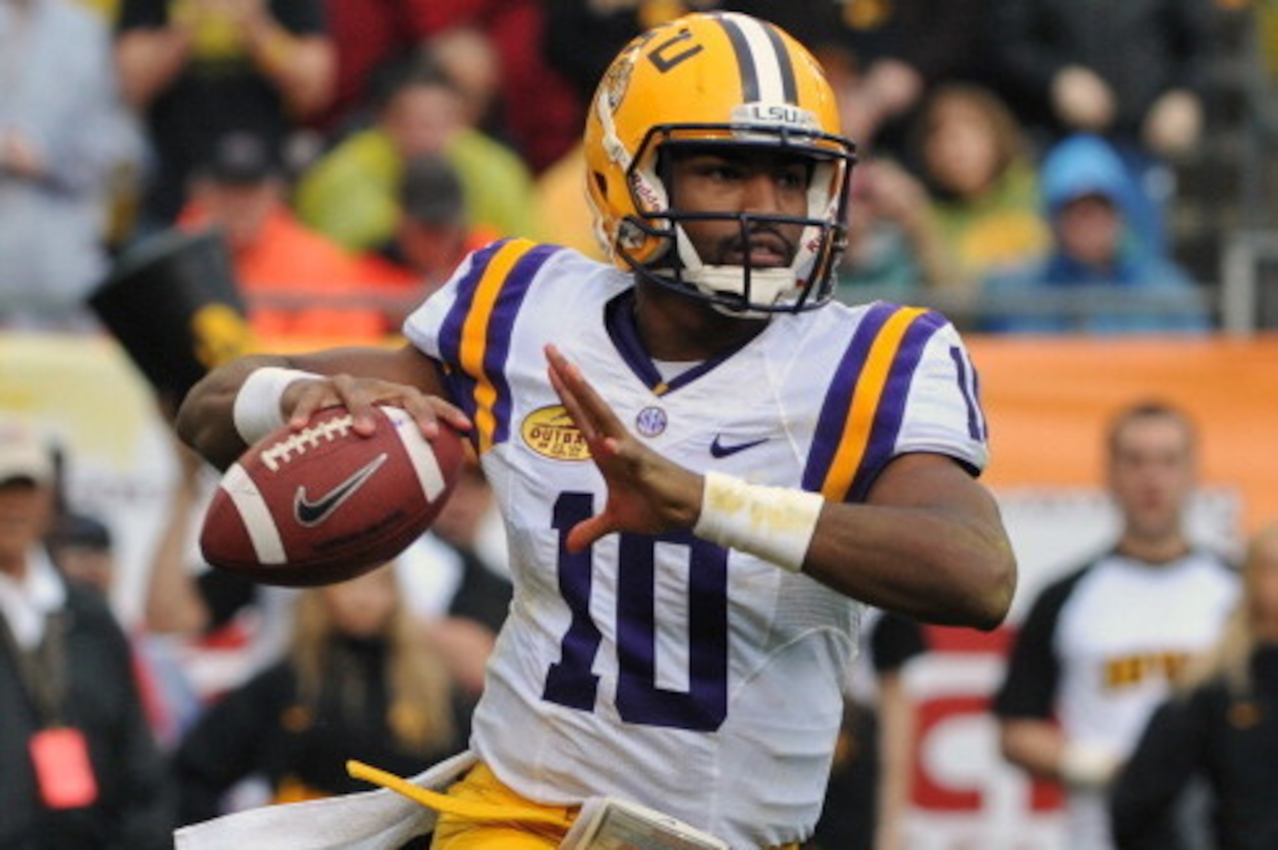 TAMPA, FL -  JANUARY 1:  Quarterback Anthony Jennings #10 of the LSU Tigers sets to pass in the second quarter against the Iowa Hawkeyes January 1, 2014  in the Outback Bowl at Raymond James Stadium in Tampa, Florida.  (Photo by Al Messerschmidt/Getty Ima