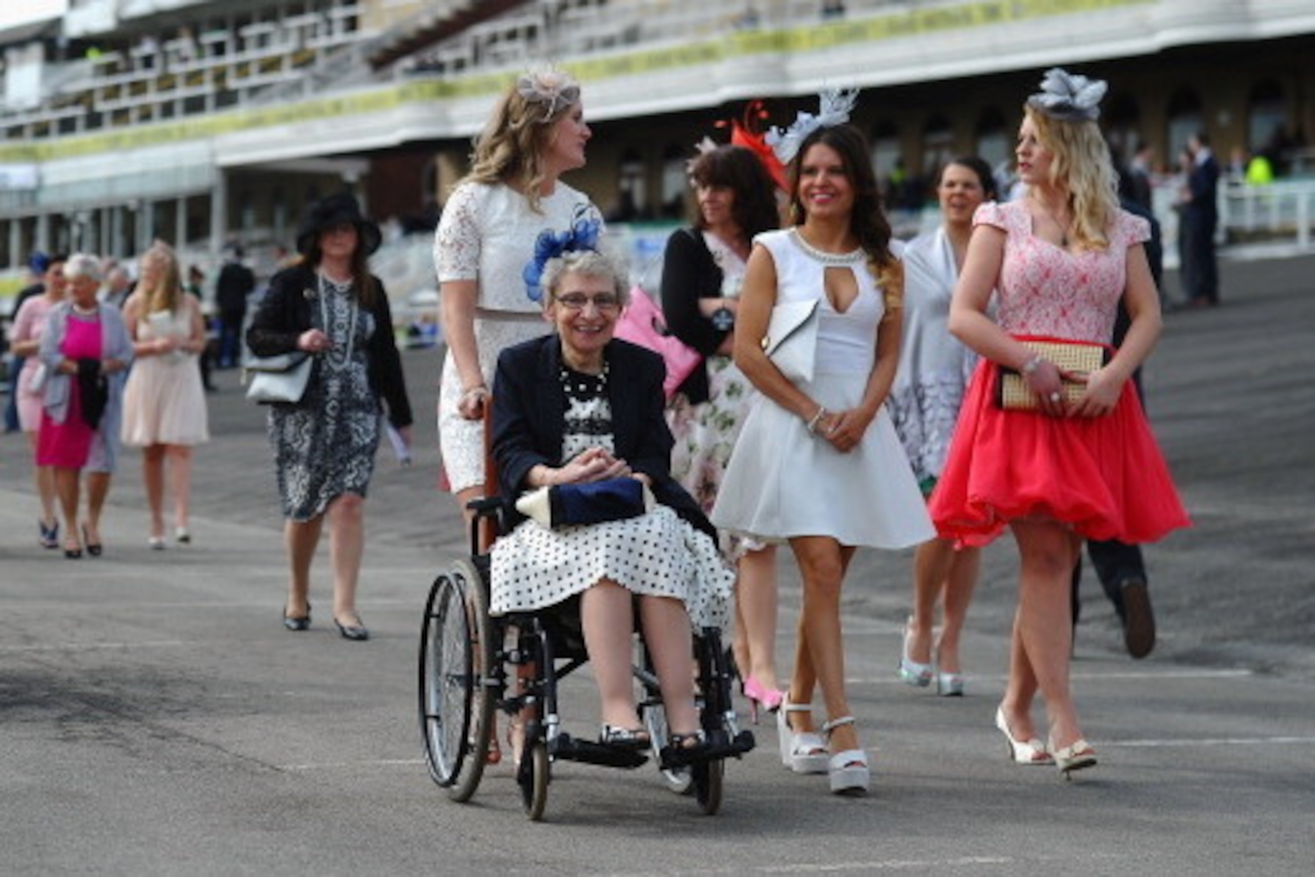 LIVERPOOL, ENGLAND - APRIL 04:  Women arrive for Ladies Day at Aintree Racecourse on April 4, 2014 in Liverpool, England.  (Photo by Laurence Griffiths/Getty Images)