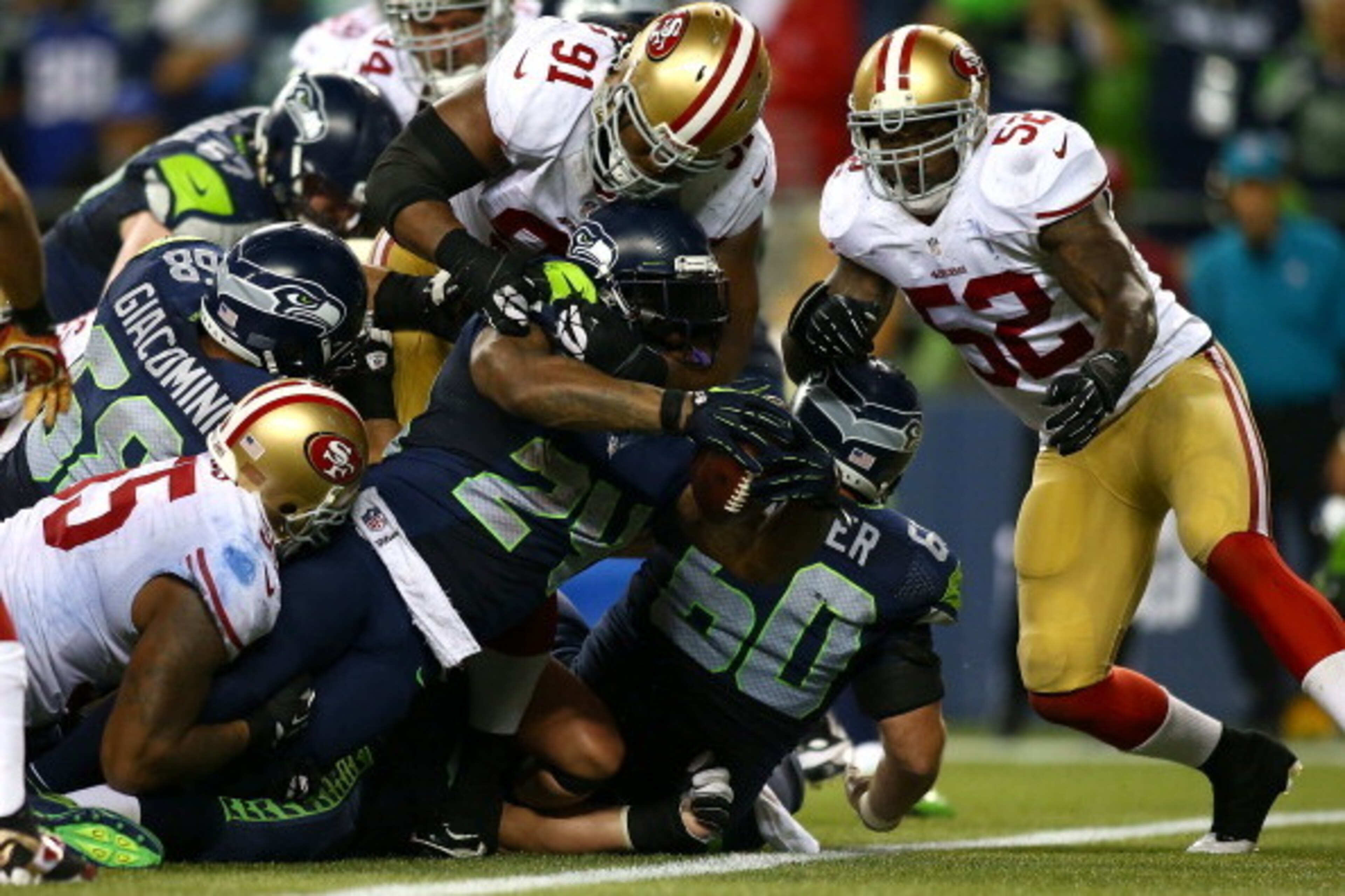 SEATTLE - SEPTEMBER 15:  Marshawn Lynch #24 of the Seattle Seahawks stretches the ball across the goal line for a touchdown against the San Francisco 49ers on September 15, 2013 at Century Link Field in Seattle, Washington.  (Photo by Jonathan Ferrey/Gett