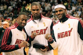 MIAMI, FL - OCTOBER 30:  (L) Dwyane Wade #3 of the Miami Heat, (C) Chris Bosh #1 of the Miami Heat and (R) LeBron James #6 of the Miami Heat pose with their 2012 NBA Championship rings prior to the game against the Boston Celtics at American Airlines Aren