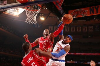 NEW YORK, NY - NOVEMBER 14: Dwight Howard #12 of the Houston Rockets blocks a shot against Carmelo Anthony #7 of the New York Knicks during a game at Madison Square Garden in New York City on November 14, 2013.  NOTE TO USER: User expressly acknowledges a