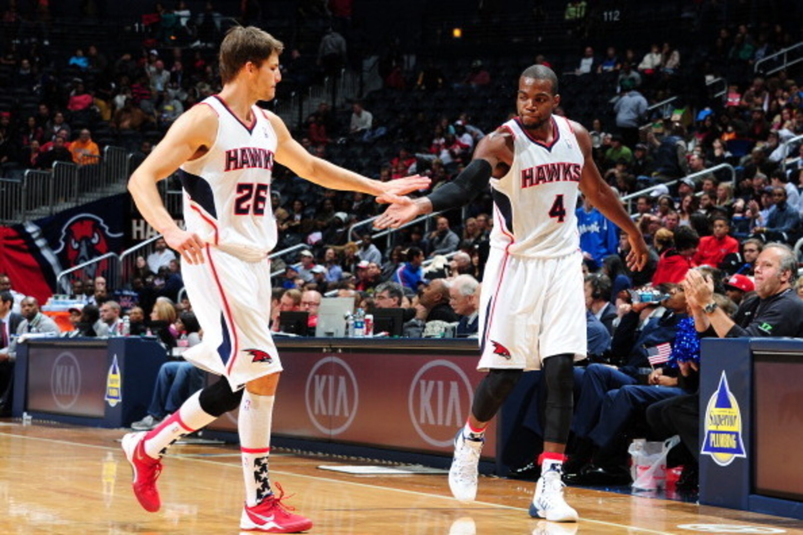 ATLANTA, GA - NOVEMBER 9: Kyle Korver #26 and Paul Millsap #4 of the Atlanta Hawks greet eachother against the Orlando Magic on November 9, 2013 at Philips Arena in Atlanta, Georgia.  NOTE TO USER: User expressly acknowledges and agrees that, by downloadi