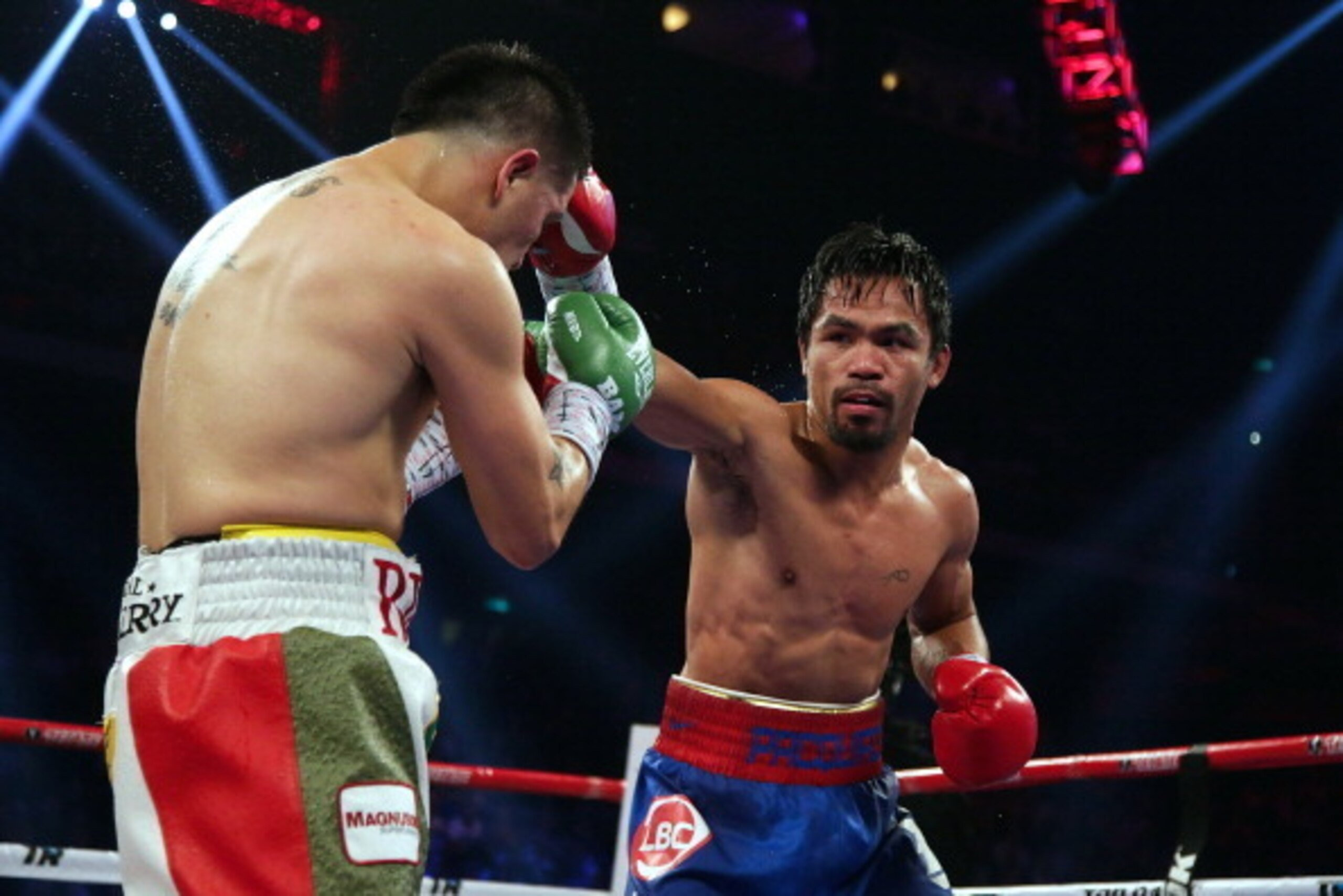 MACAU - NOVEMBER 24:  Manny Pacquiao (R) of the Philippines punches Brandon Rios of the U.S. during their 'Clash in Cotai' WBO International Welterweight title fight on November 24, 2013 in Macau.  (Photo by Nicky Loh/Getty Images)