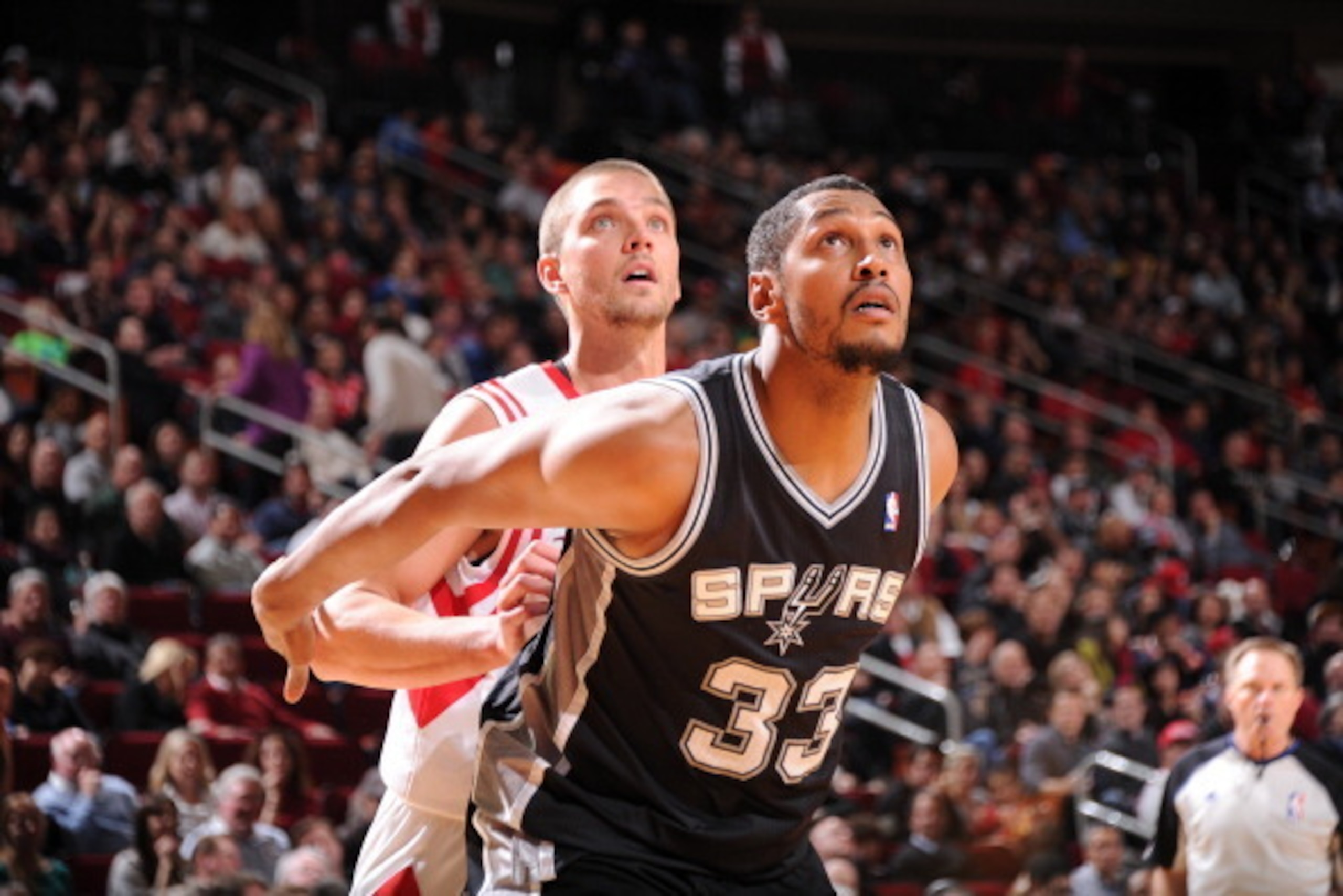 HOUSTON, TX - JANUARY 28:  Chandler Parsons #25 of the Houston Rockets and Boris Diaw #33 of the San Antonio Spurs battle for the rebound on January 28, 2014 at the Toyota Center in Houston, Texas. NOTE TO USER: User expressly acknowledges and agrees that